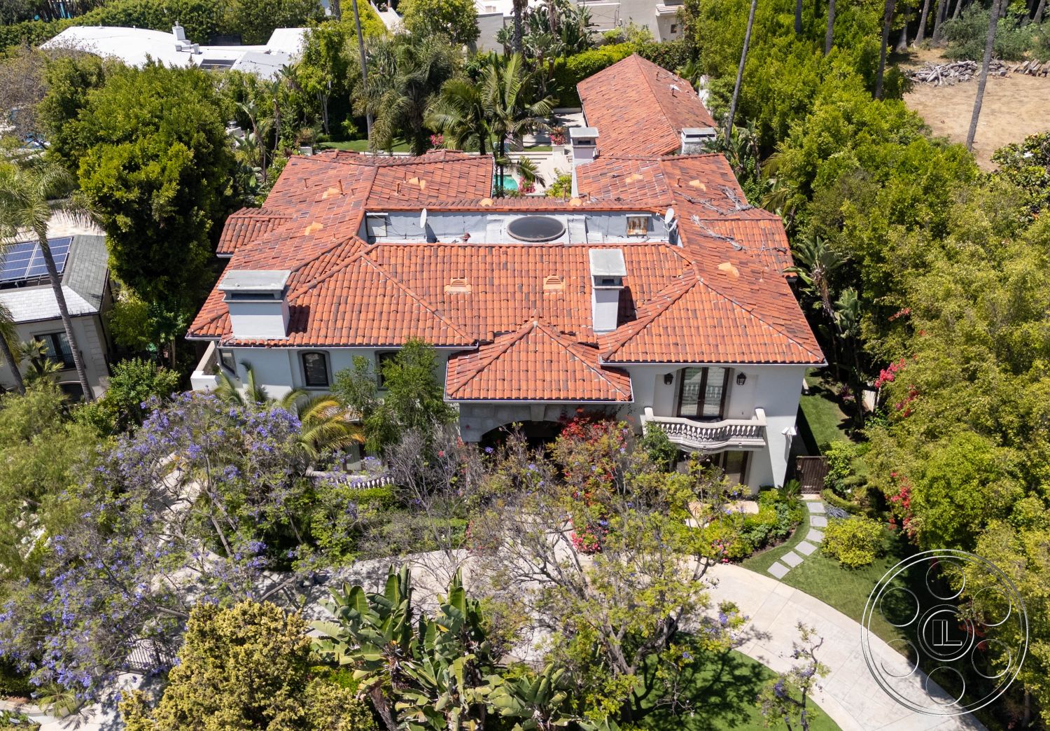Medit 165 - exterior, white stucco walls, outdoor space, palm trees, natural lighting, tropical plants, green foliage, colorful flowers, circular driveway, lush landscaping, pool area, elegant, balcony, luxurious, Mediterranean architecture, scenic, terracotta roof tiles, private residence, veranda, modern residential, garden pathways, pedestrian walkway