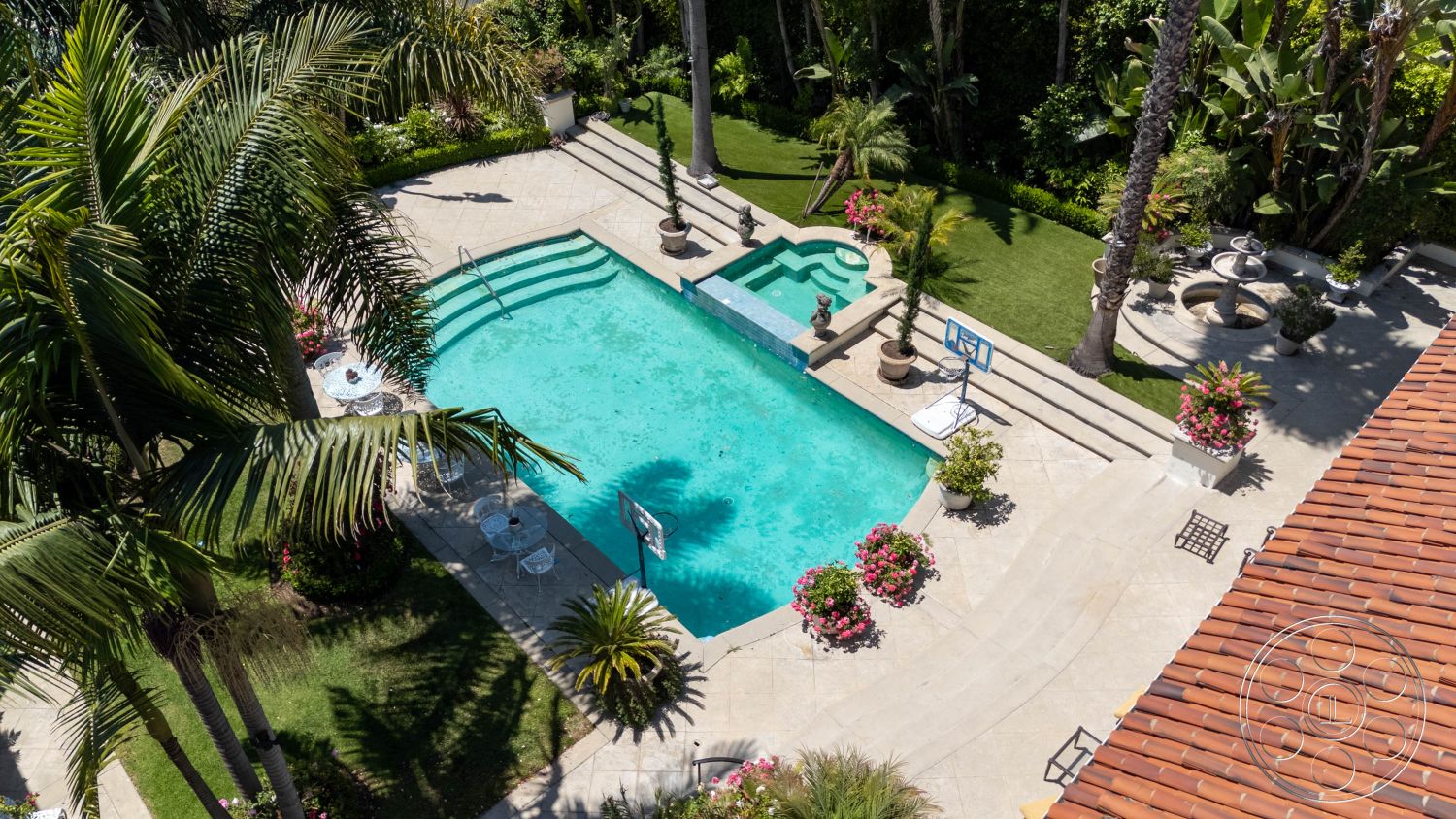 Medit 165 - natural light, exterior, landscaped garden, palm trees, modern design, pool, stone patio, jacuzzi, outdoor seating, entertaining space, elegant, basketball hoop, luxurious, family-friendly, tropical, bright blue water, flowers, privacy hedges, decorative pots, tile