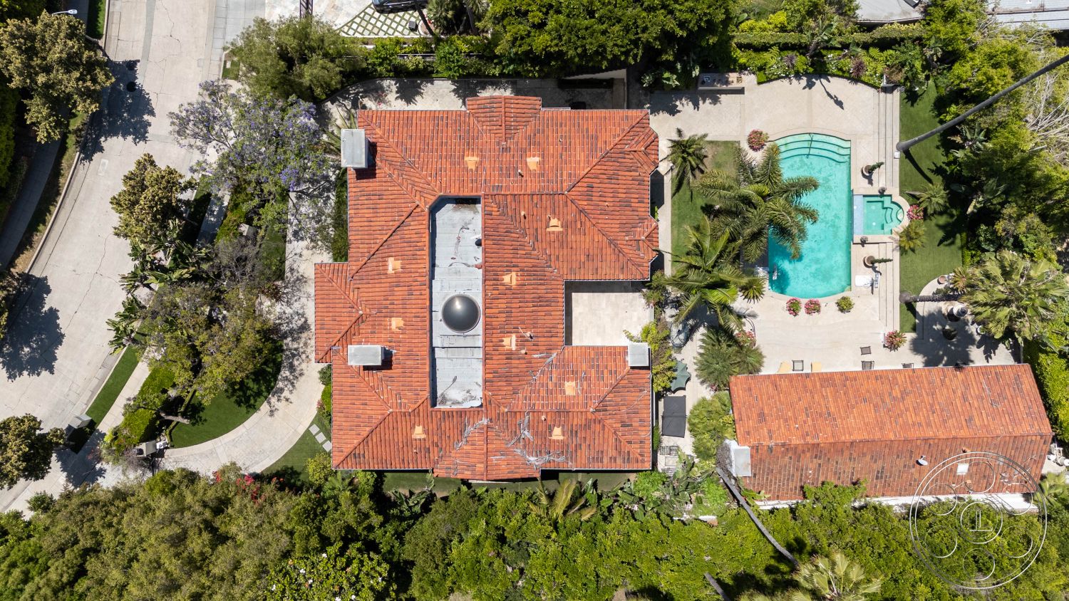 Medit 165 - natural light, lush greenery, open layout, exterior space, tropical plants, patio area, landscaped yard, swimming pool, decorative planters, elevated view, sunny ambiance, Spanish Revival architecture, outdoor leisure, tile roof, private residence, residential setting, concrete paving, fenced yard, modern outdoor seating, red clay tiles