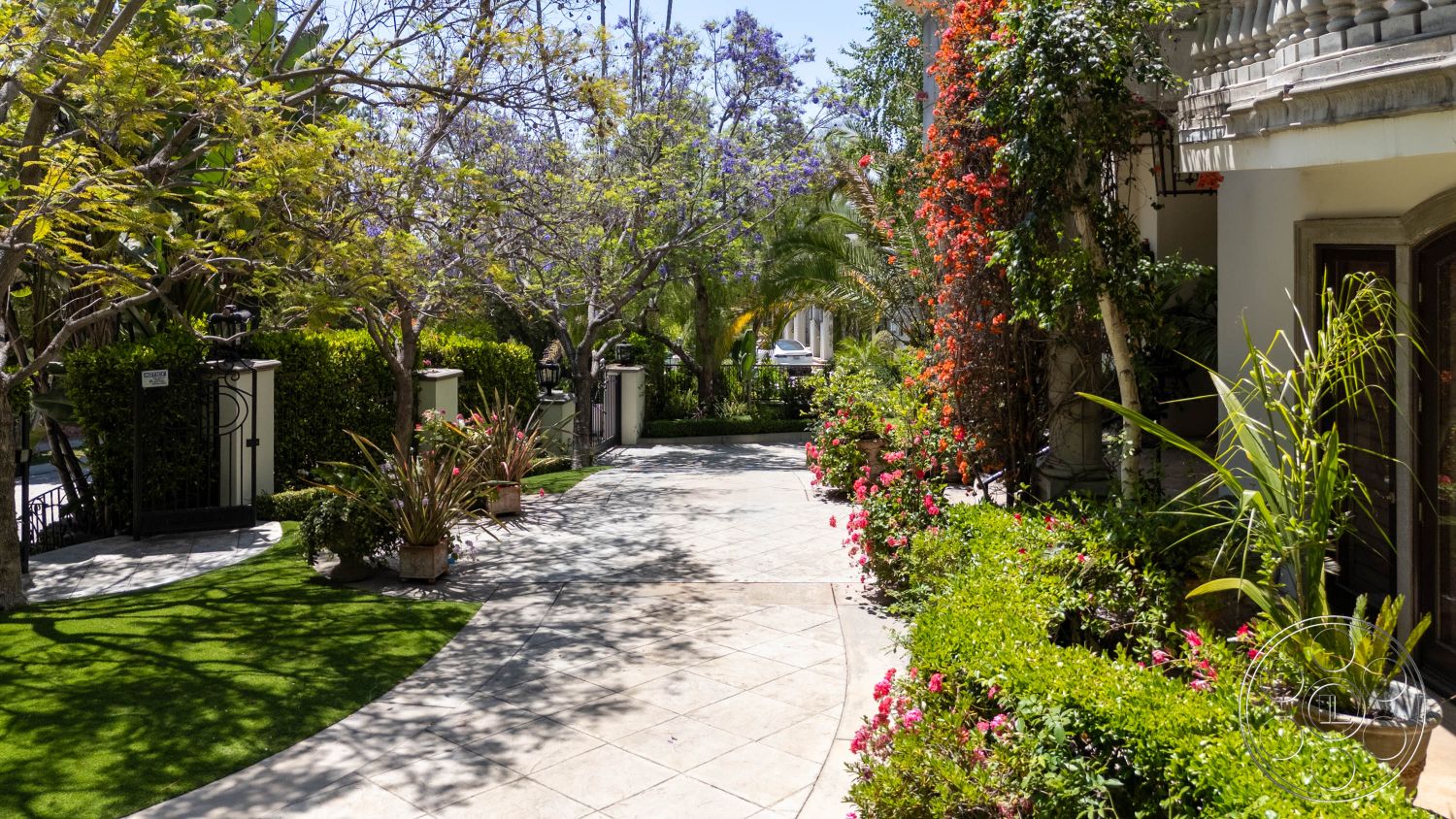 Medit 165 - natural light, exterior, residential, modern architecture, lush greenery, serene atmosphere, well-maintained, tropical plants, curved pathway, landscaped yard, pathway, garden, gated entrance, urban oasis, scenic, calming colors, decorative pots, vibrant blooms, planted flowers, domestic, ambulant setting