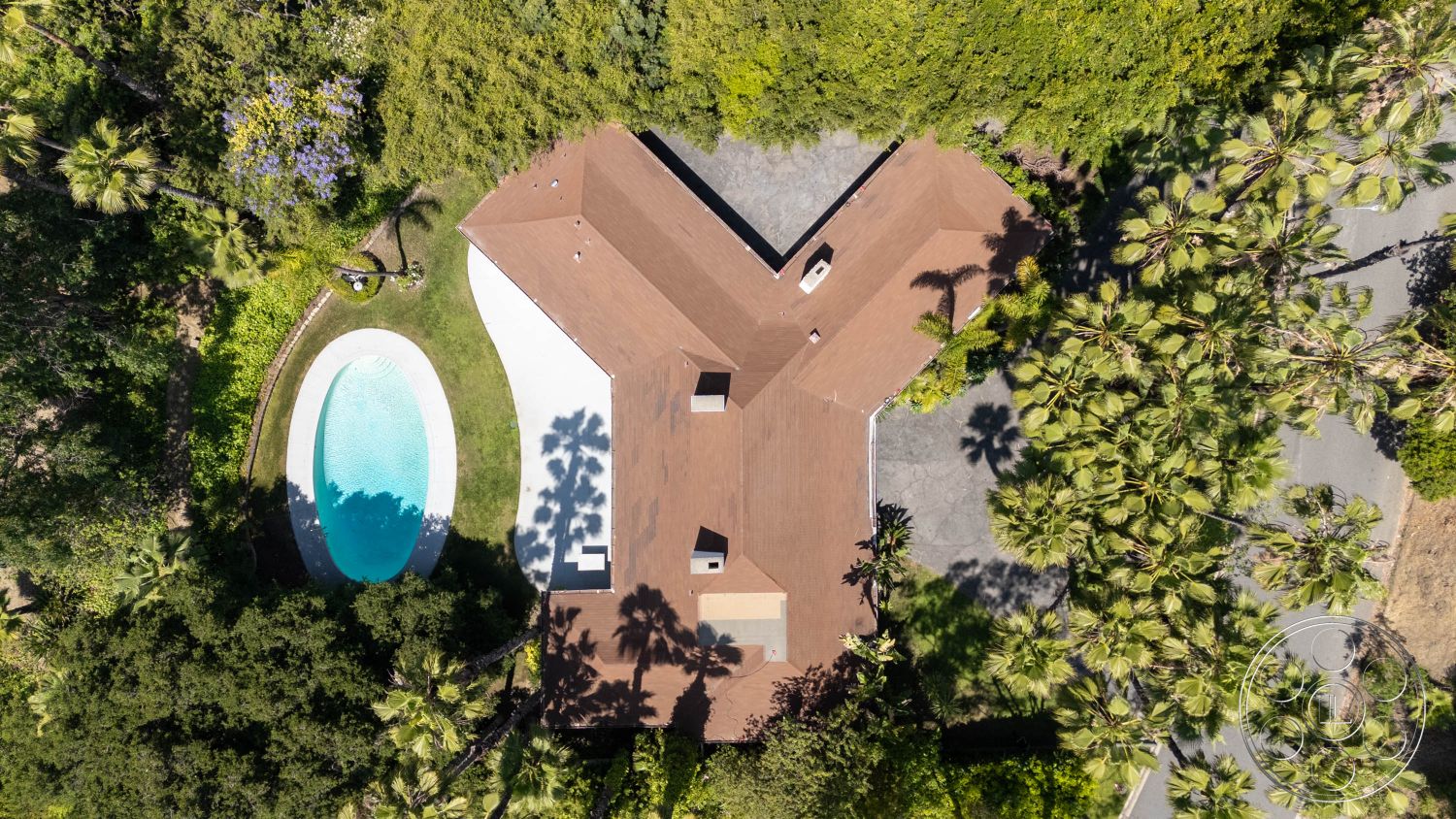 MCM 23 - natural light, exterior, contemporary design, residential, outdoor space, modern architecture, driveway, palm trees, scenic view, tropical plants, pool, patio area, lush landscaping, green lawn, aerial view, concrete driveway, vibrant greenery, peaceful setting, family home, garden area, relaxing environment, unique roof design, oval swimming pool, wood roof, brown roofing, high privacy