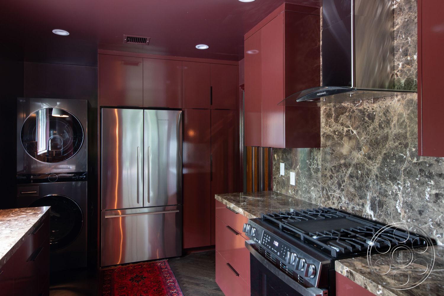 Bungalow 56 - dark wood cabinetry, contemporary style, textured wall treatments, stainless steel refrigerator, elegant color palette, marble kitchen countertops, open kitchen layout, interior kitchen, minimalist kitchen design, polished marble backsplash, stainless steel gas range, washer dryer combo unit, modern appliance integration, dark laminate flooring, bright recessed lighting, functional kitchen storage