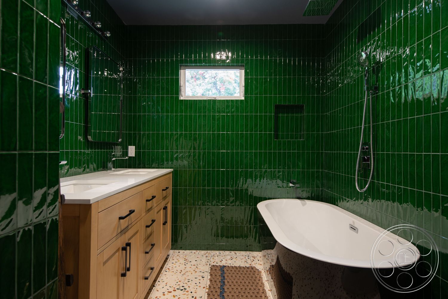 Bungalow 56 - freestanding bathtub, textured concrete flooring, window with natural light, green glazed tile bathroom walls, minimalist bathroom design, white marble vanity countertop, natural wood bathroom cabinetry, modern shower fixture, interior bathroom space, brushed steel plumbing fixtures