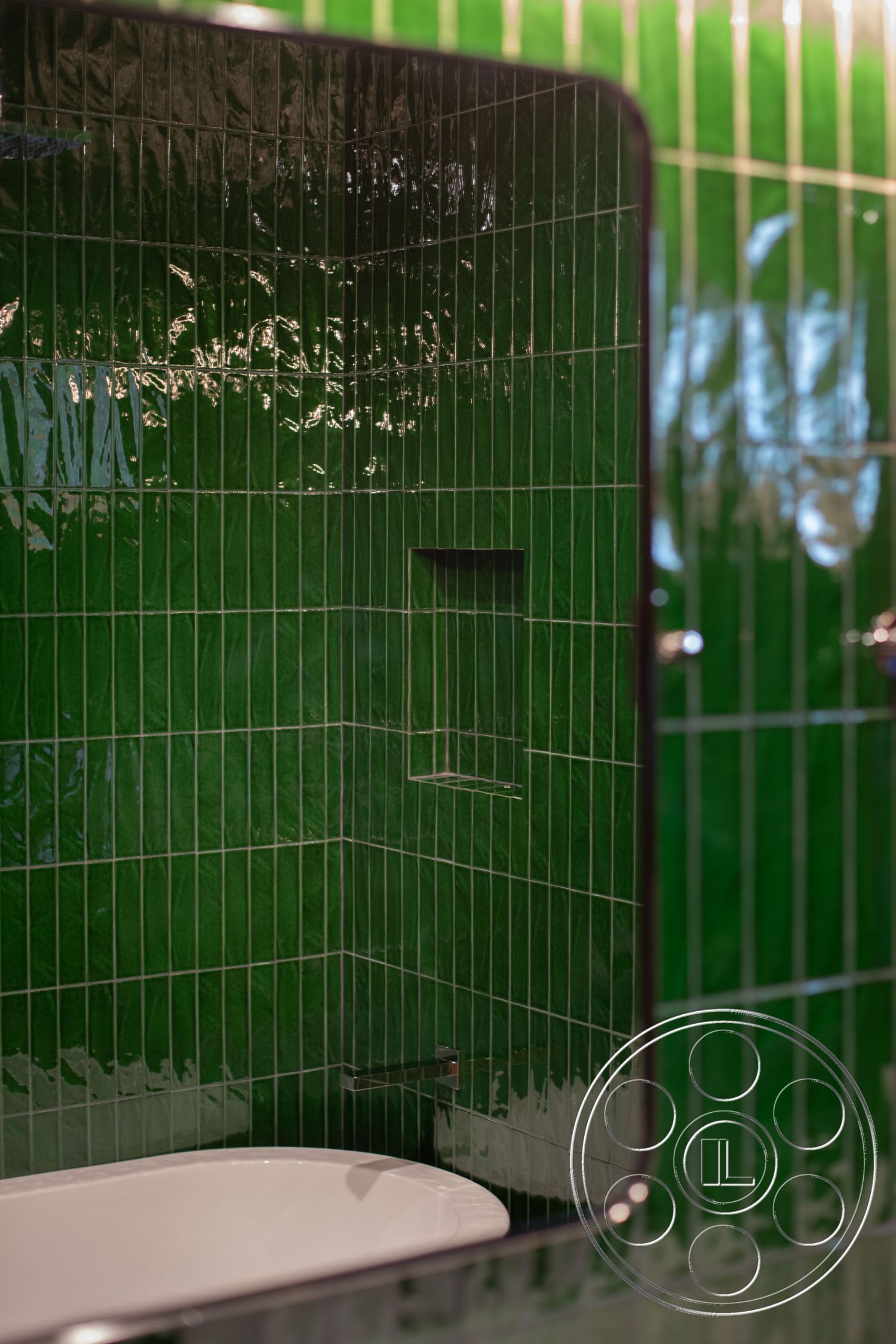 Bungalow 56 - green glossy tile bathroom walls, interior bathroom, linear tile shower design, textured green ceramic tile, modern freestanding bathtub, chrome faucet fixtures, built-in shower niche, curved shower enclosure, sleek contemporary bathroom, reflective tile surfaces