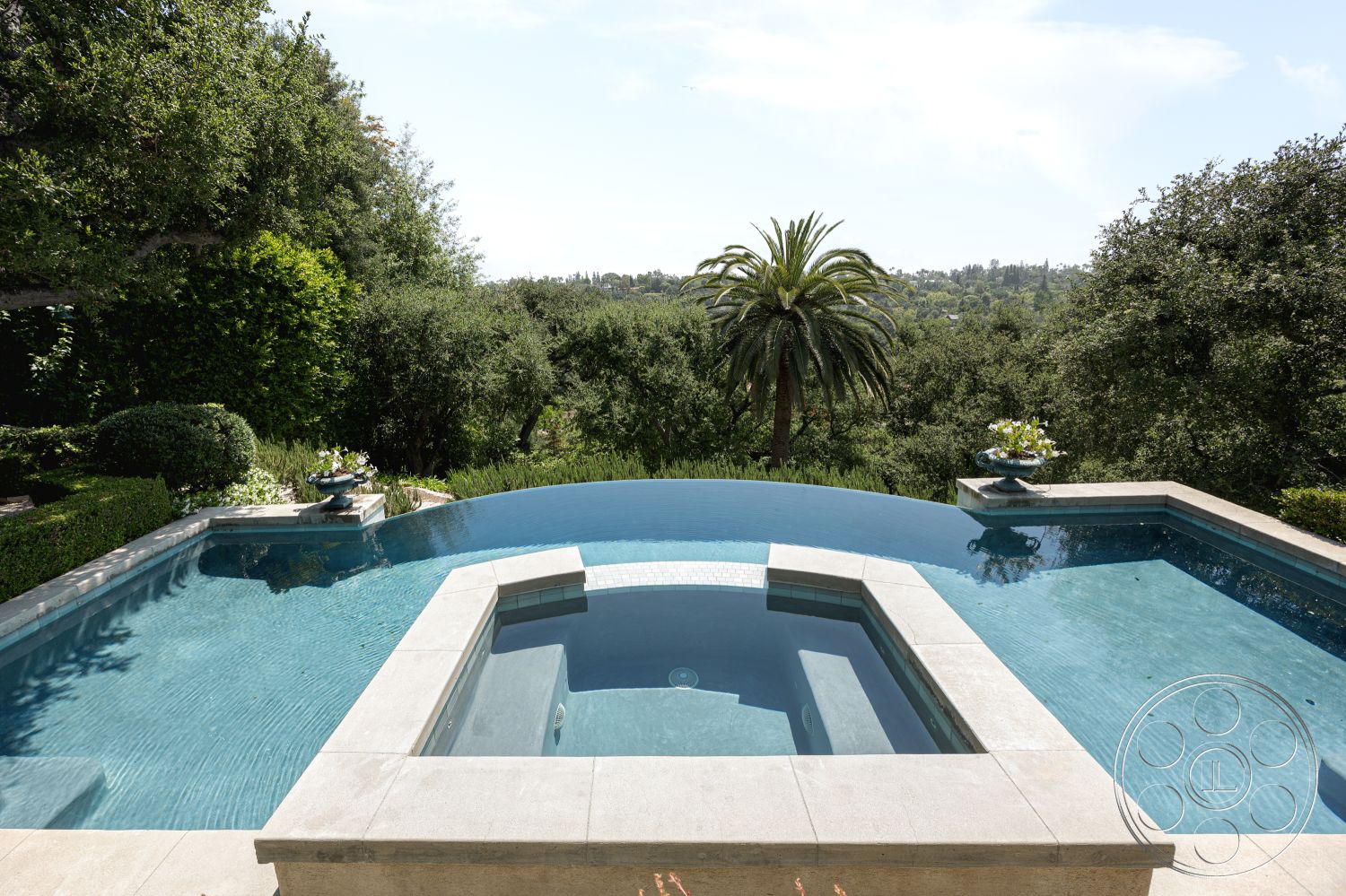 The Regent - urban residential setting, rectangular pool shape, luxurious outdoor retreat, concrete pool border, surrounded by lush greenery, landscaped garden patio, palm tree landscape, interior infinity pool, panoramic hillside view, modern outdoor spa, stone coping, contemporary water feature, tile pool flooring, sun-drenched pool area