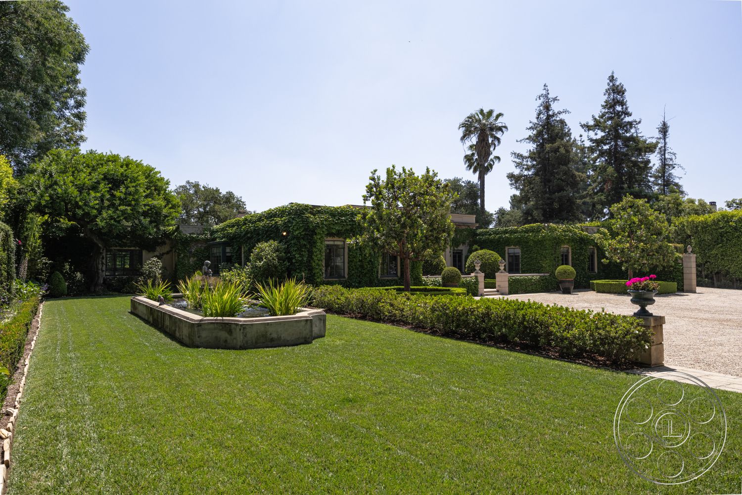 The Regent - paved driveway, ornamental plants, luxurious estate, formal garden design, urban residential setting, sunny outdoor space, landscaped grounds, exterior garden, natural grass landscape, concrete flower bed, tall conifer trees, low-maintenance shrubbery, broadleaf evergreen trees, green vine-covered walls, sculptural outdoor elements, potted plants with flowers