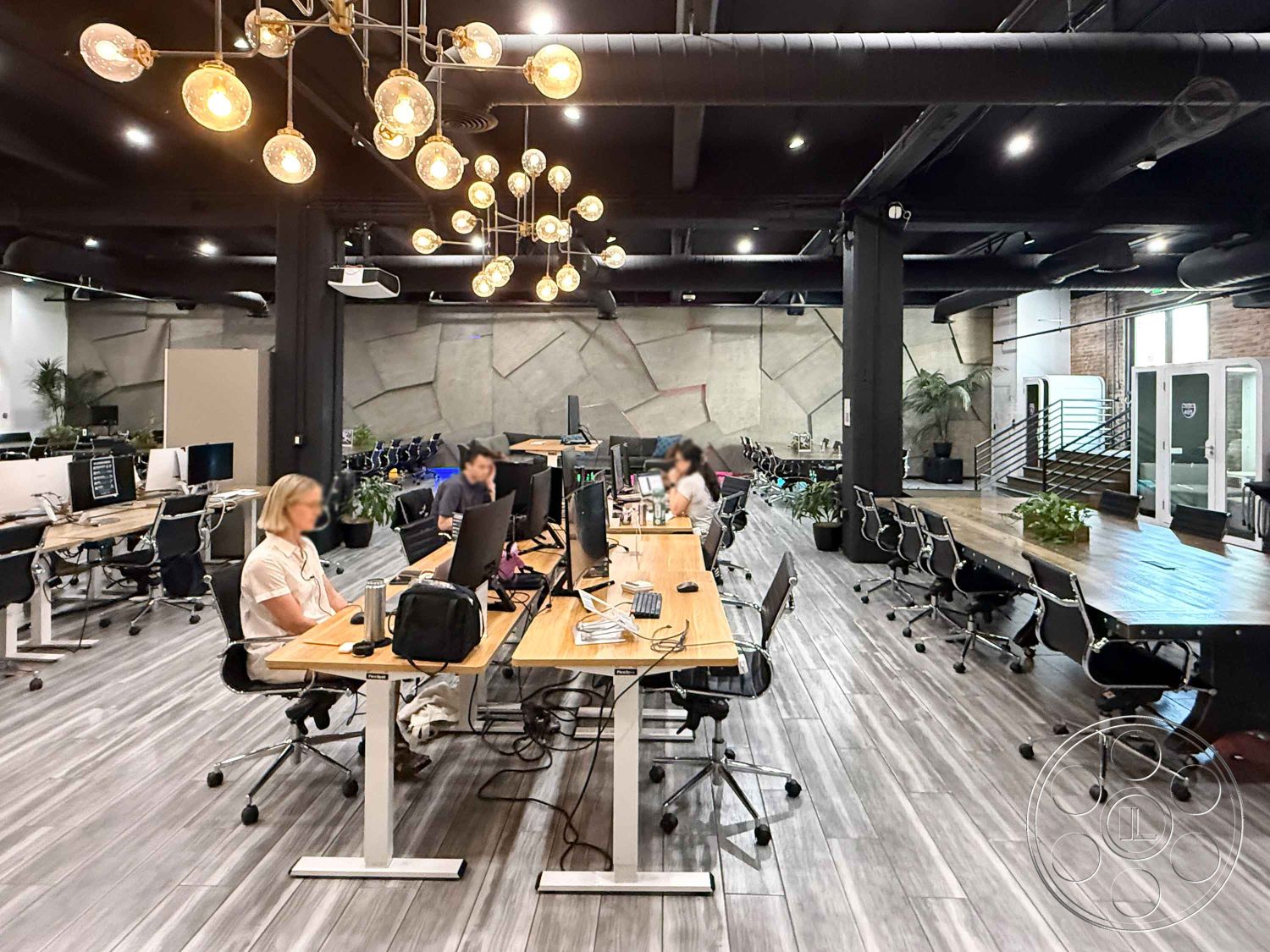 Office 124 - modern decor elements, sliding glass doors, exposed brick walls, large conference table, floor-to-ceiling windows, open office layout, glass partition walls, contemporary design style, urban office environment, concrete accent wall, wooden office desks, industrial hanging light fixtures, polished hardwood floor, black metal ceiling beams, modern ergonomic office chairs, plant-filled workspace, interior workspace
