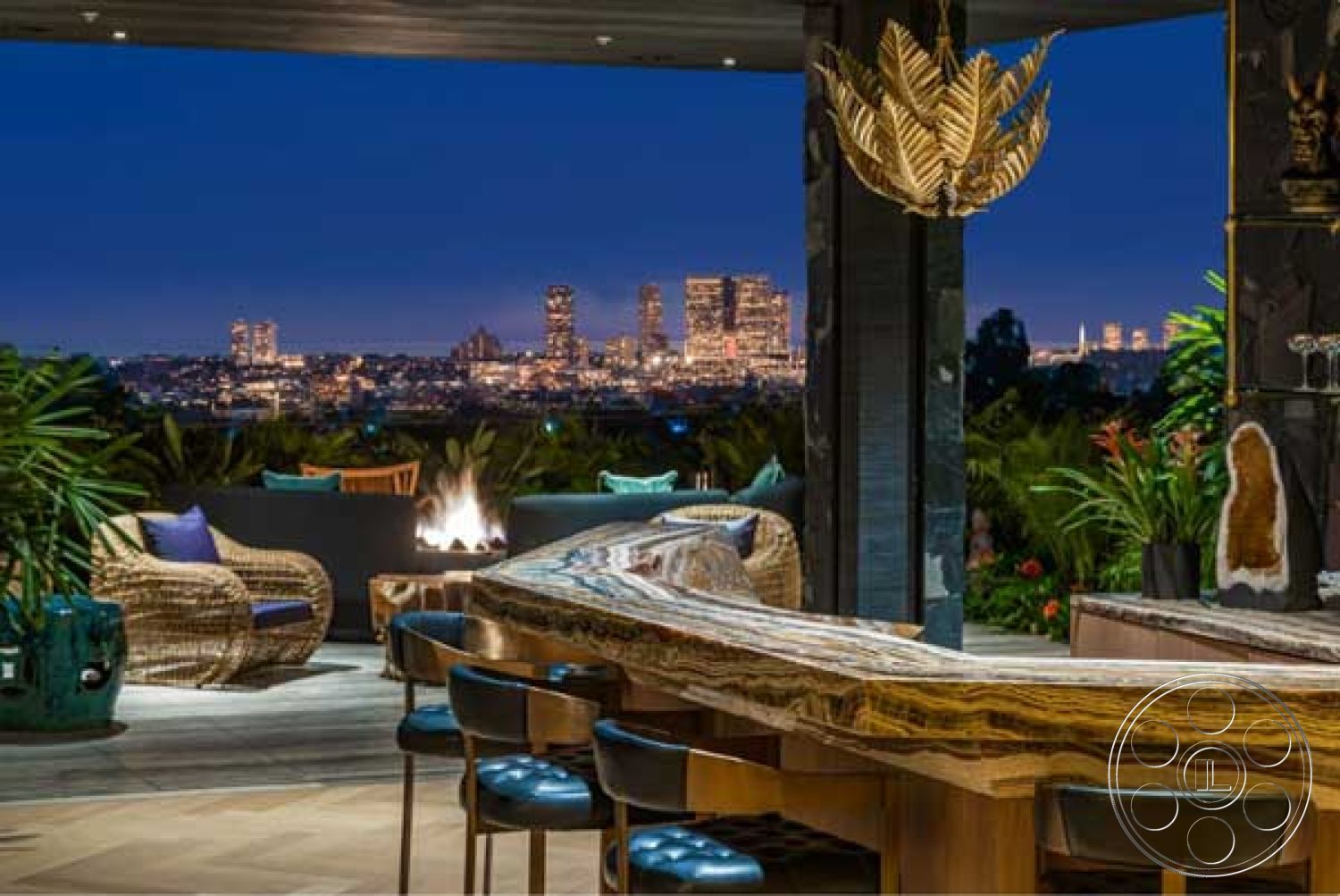 Modern 507 - exposed wooden ceiling, modern outdoor furniture, interior-exterior flow, city skyline view, open-air living space, natural stone countertop, decorative pendant lighting, textured landscaping, contemporary architectural design, floor-to-ceiling glass walls, urban rooftop setting, outdoor bar area, woven rattan chairs, illuminated fire feature, smooth wooden bar top, lush tropical planting, ambient evening lighting, sleek seating arrangement