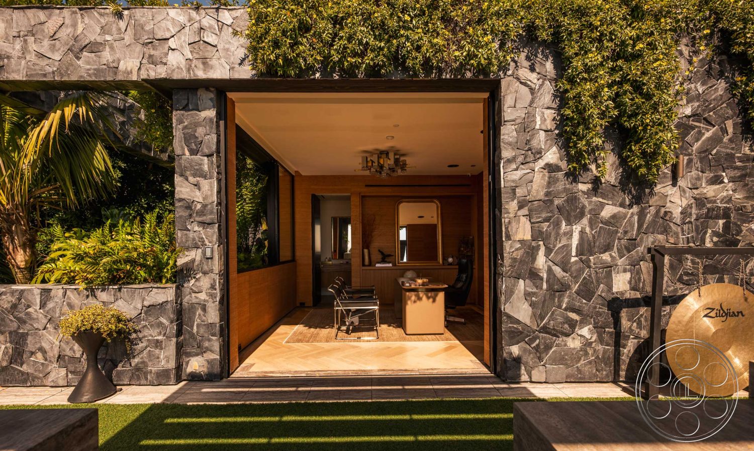 Modern 507 - minimalist aesthetic, modern light fixtures, glass sliding doors, outdoor seating area, decorative planter, floor-to-ceiling windows, textured plaster ceiling, lush tropical landscaping, urban residential setting, concrete patio flooring, modern workspace design, exterior stone wall cladding, exposed rock facade, open architectural layout, wood panel interior walls, rectangular patio section, green wall with foliage