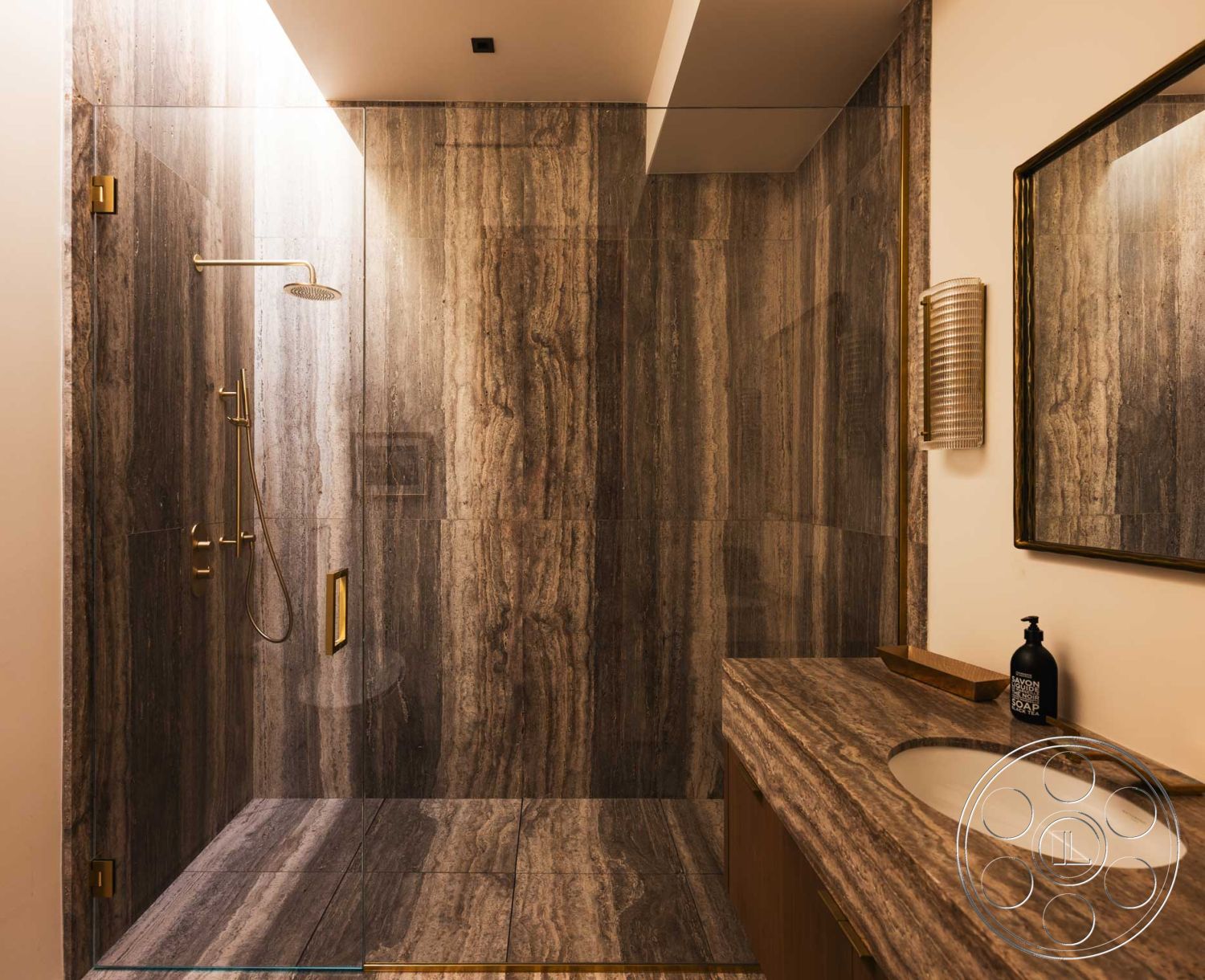 Modern 507 - interior neutral color palette, interior recessed lighting, interior textured wall treatment, interior gold faucet fixtures, interior wood cabinetry, interior marble shower walls, interior glass shower enclosure, interior marble shower floor, interior marble vanity countertop, interior framed mirror, interior modern bathroom design, interior contemporary lighting fixtures, interior minimalist bathroom, interior spa-like atmosphere