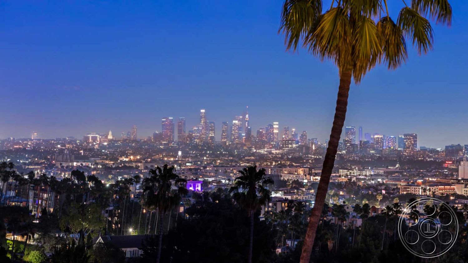 Modern 507 - exterior, glass railings, surrounding greenery, urban rooftop, city skyline view, suburban environment, open air setting, hilltop setting, landscape with palm trees, nighttime cityscape, twilight ambiance, modern architecture elements, view of downtown Los Angeles, exposed balconies