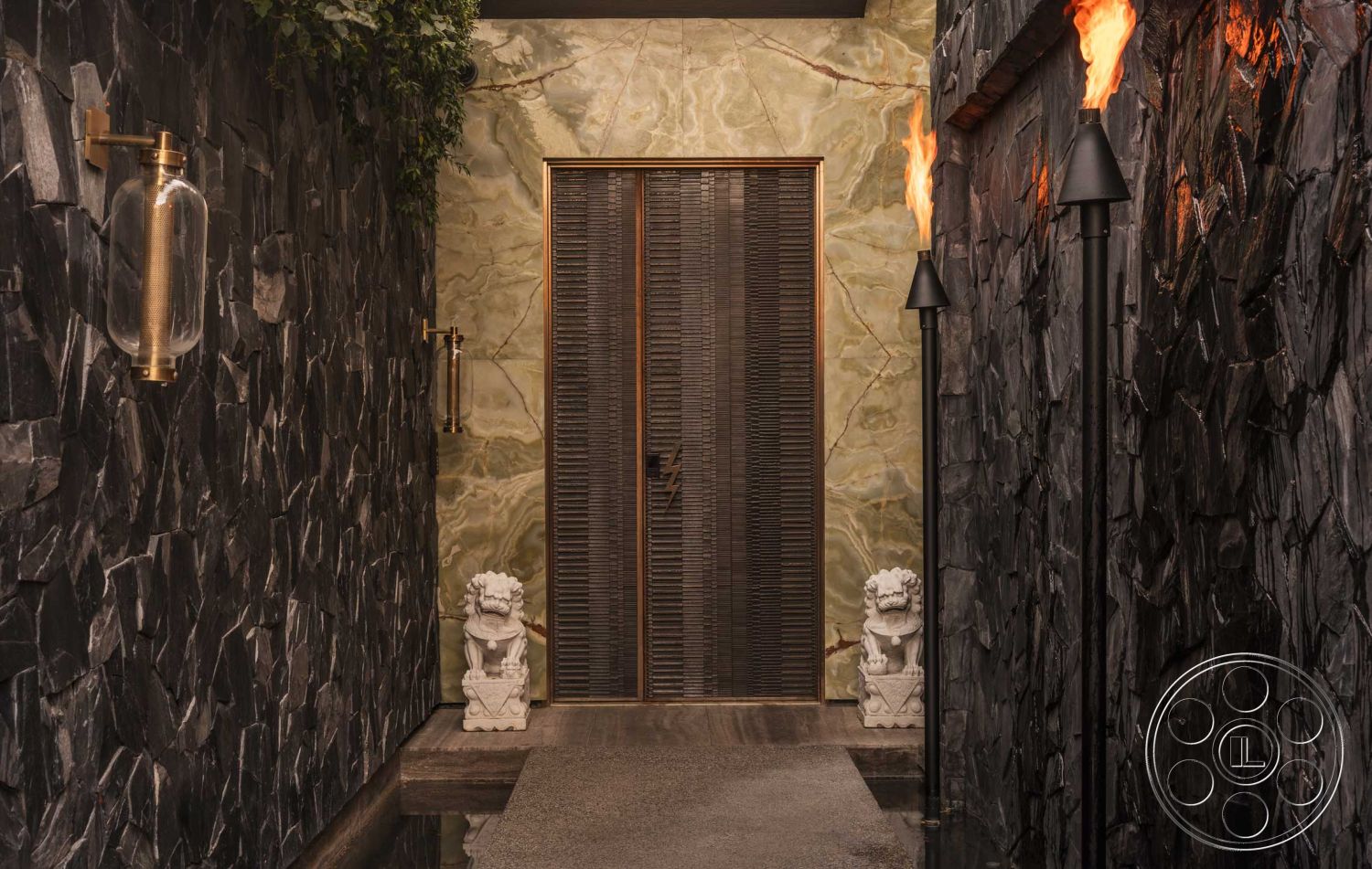 Modern 507 - interior polished concrete flooring, exterior stone feature wall, interior warm color palette, interior onyx accent wall, exterior textured slate wall, interior wooden door with slatted design, exterior black stone wall cladding, exterior wall-mounted torch lighting, exterior decorative lion statue, interior natural stone stepping stones, exterior landscaped entrance, interior architectural details with gold fixtures, exterior bamboo accents, interior ambient lighting fixtures, exterior walkway with natural stones, exterior enclosed corridor, interior high ceiling with contemporary design, exterior lush greenery backdrop, interior structured entryway, exterior modern minimalistic design