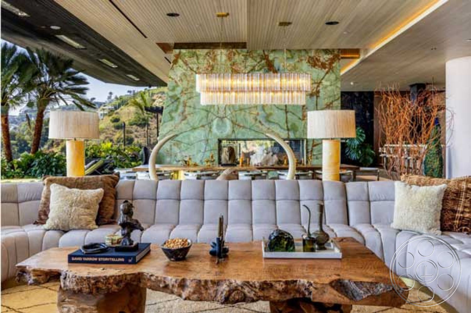 Modern 507 - glass sliding doors, textured pillows, modern art decor, decorative indoor plants, open floor plan living area, luxury chandelier lighting, exposed natural stone feature wall, polished marble accent wall, organic shape coffee table, fabric sectional sofa, large windows with hillside view, tropical landscaping in view, wood veneer ceiling, contemporary floor plan