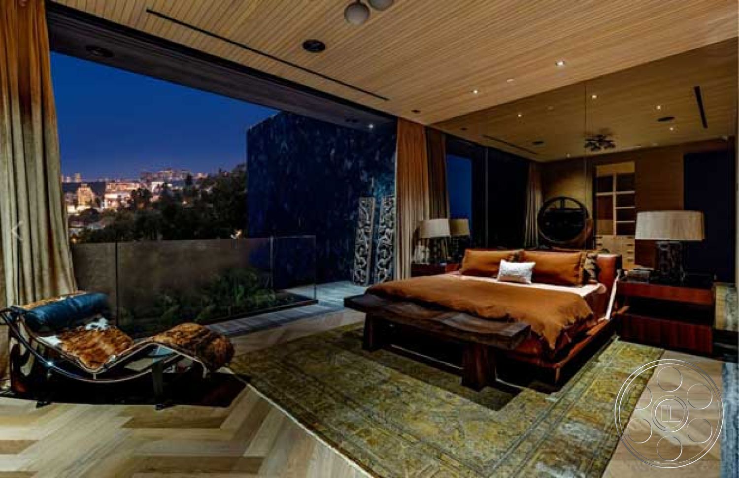 Modern 507 - modern pendant lighting, dark wood furniture, hardwood bedroom floors, luxury master bedroom, glass balcony railing, floor-to-ceiling windows with city skyline view, exposed concrete accent wall, vaulted ceiling with wood paneling, warm-toned bedding, textured wall art decor, dimmed recessed lighting, large area rug with intricate pattern
