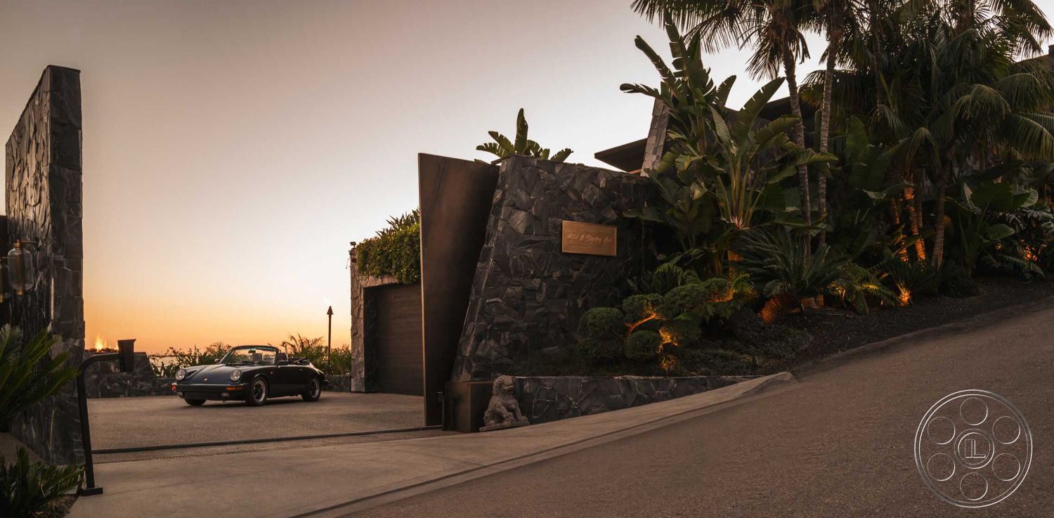 Modern 507 - exterior concrete driveway, exterior landscaped garden, exterior stone feature wall, exterior contemporary architecture, exterior tropical palm plants, exterior modern metal gate, exterior illuminated pathway, exterior asphalt drive slope, exterior natural stone cladding, exterior minimalist garage door, exterior ocean sunset view, exterior circular driveway layout, interior steel decorative accents, interior tropical landscaping elements