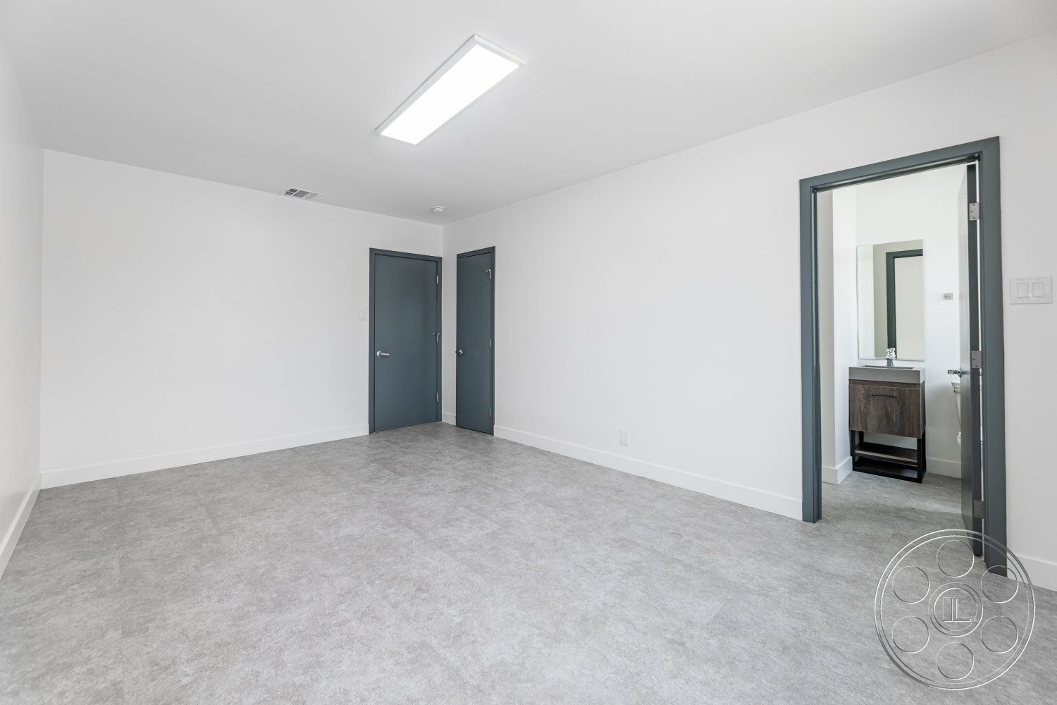 Office 125 - neutral color palette, natural light, open floor plan, interior space, floor-to-ceiling windows, vinyl flooring, recessed lighting fixtures, modern minimalist design, white painted walls, light grey vinyl floor tiles, dark grey interior doors, square room layout, simple modern vanity