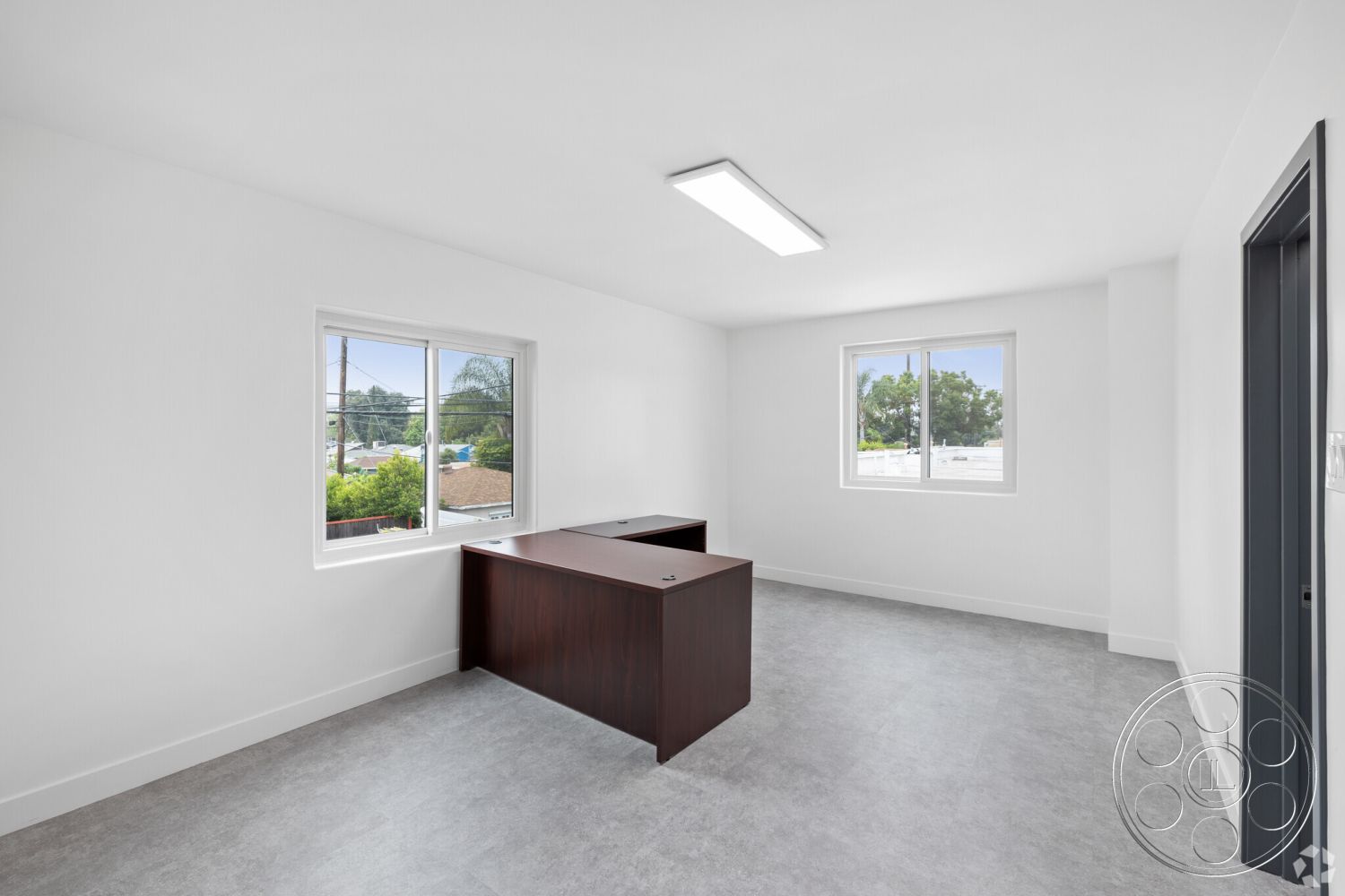 Office 125 - natural light, minimalist design, open layout, vinyl flooring, white painted walls, interior office space, contemporary office environment, laminate office desk, large double-pane windows, modern fluorescent lighting, urban surroundings