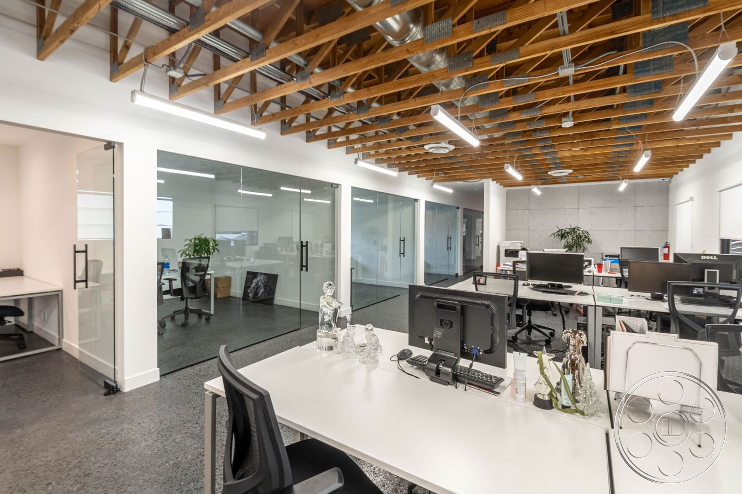 Office 126 - office, exposed wood beam ceiling, neutral color palette, polished concrete flooring, collaborative workspace, glass partition walls, modern office layout, urban office setting, black ergonomic office chairs, minimalist furniture design, contemporary architectural details, glass office doors, bright interior lighting, industrial style lighting fixtures, concrete accent walls, open plan office, white computer desks, green indoor plant decor, transparent office partition, ceiling-mounted HVAC system, functional workspace environment