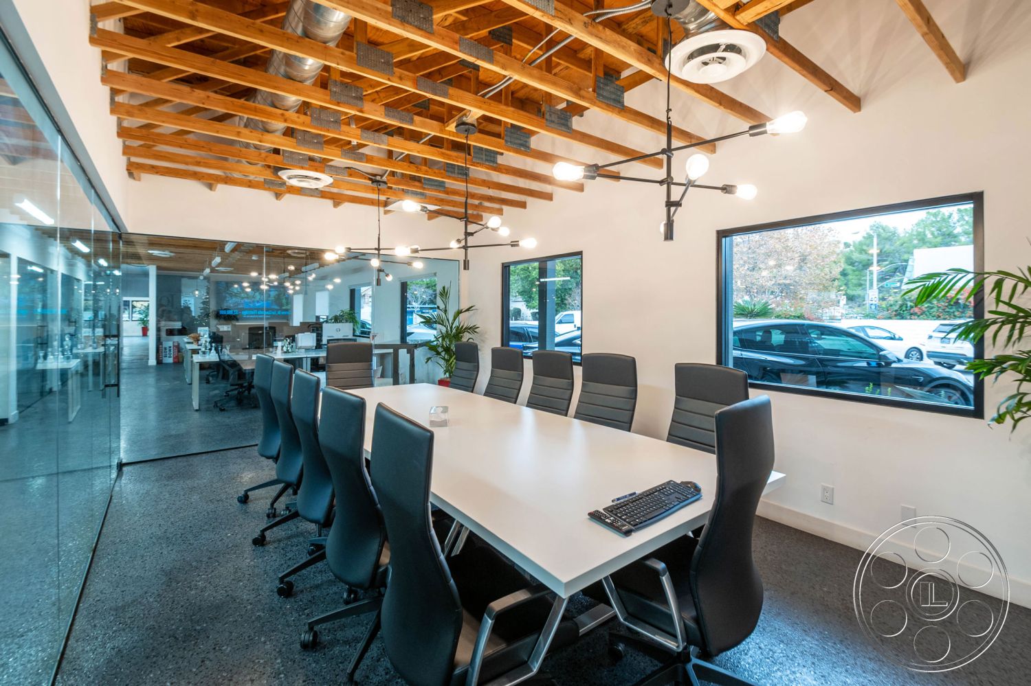 Office 126 - conference room, concrete floor, minimalist design, polished concrete flooring, green indoor plants, exposed wood ceiling beams, glass partition walls, natural light interior, ergonomic office chairs, modern conference table, open office layout, industrial pendant lighting, large windows with black frames, clean white painted walls, frosted glass office walls, decorative ceiling light fixtures, bright collaborative workspace