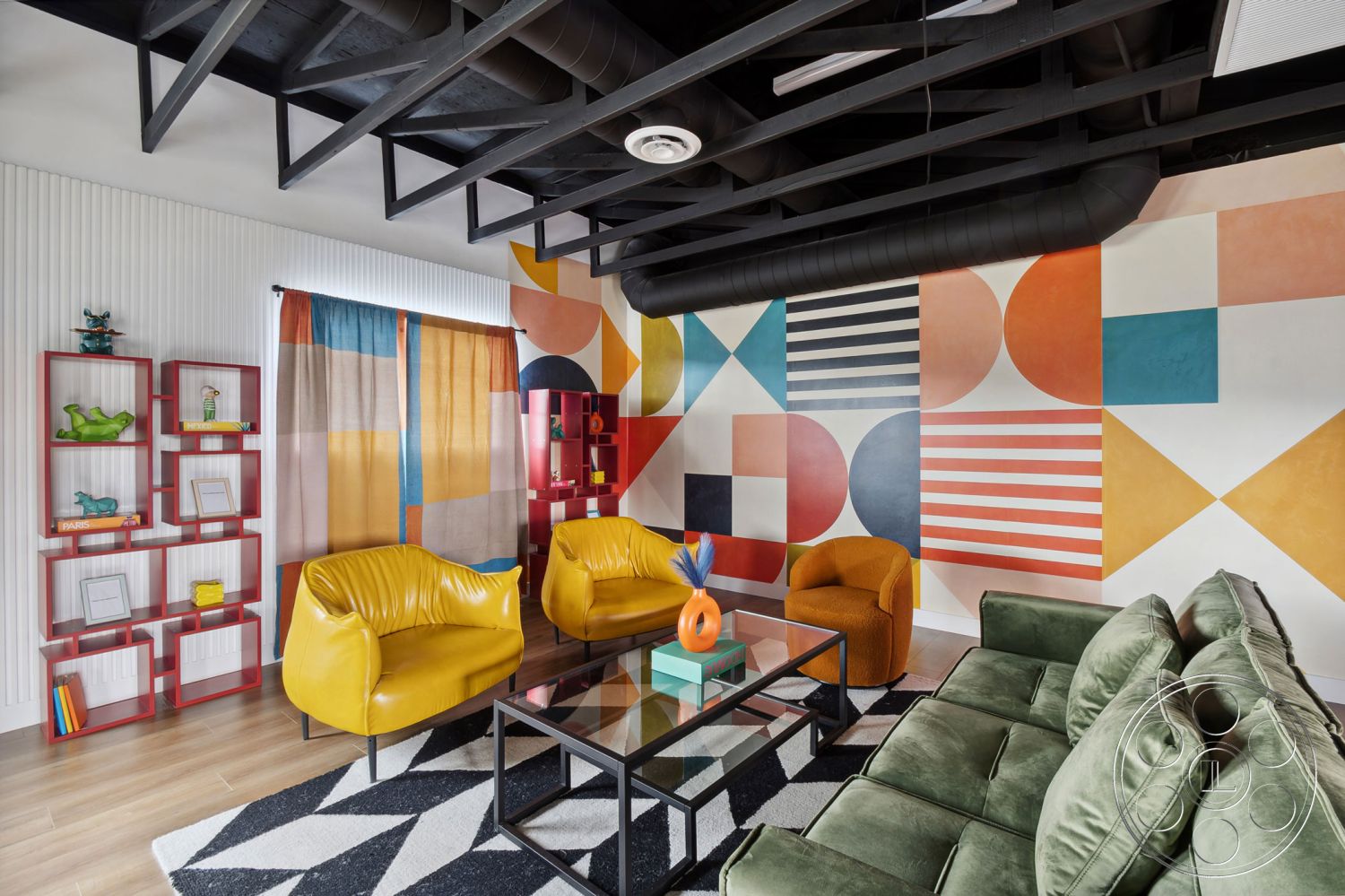 Office 126 - glass coffee table, green velvet sofa, interior living room, textured plaster wall treatment, black painted metal ceiling beams, geometric accent wall art, yellow upholstered armchairs, black and white geometric area rug, colorful curtain panels, red industrial shelving units, wood-look laminate flooring
