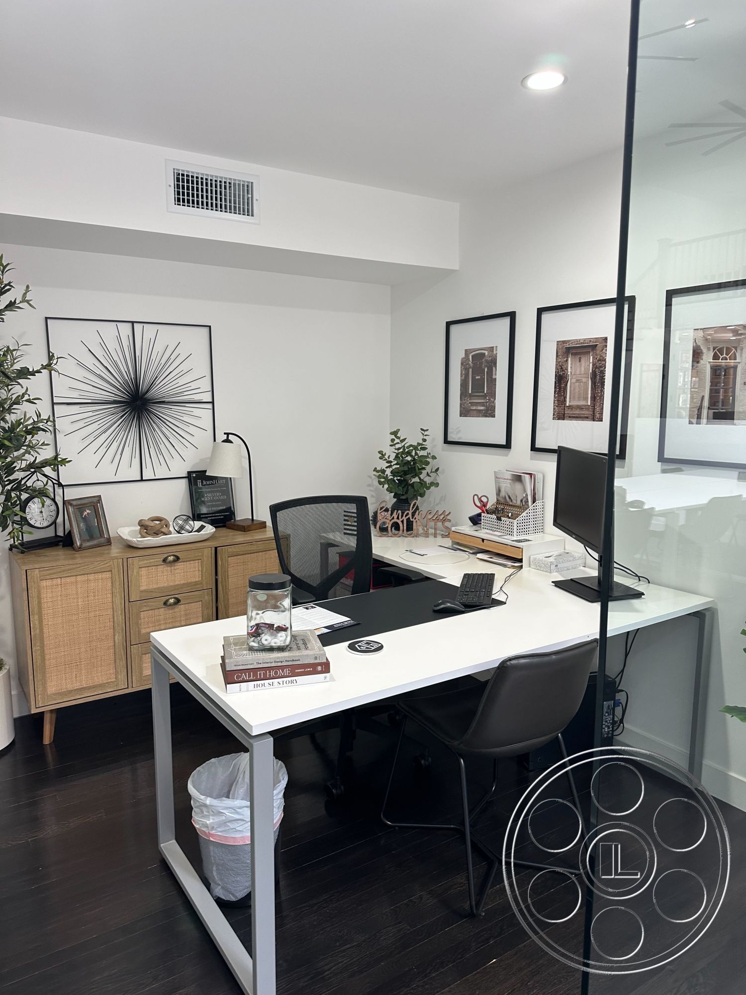 Office 127 - minimalist design elements, decorative wall art, dark hardwood flooring, potted greenery, ergonomic office chair, glass partition walls, white painted walls, contemporary office decor, interior office space, modern desk with metal legs, woven storage cabinet, black and white framed prints, paper wastebasket, workspace with computer setup