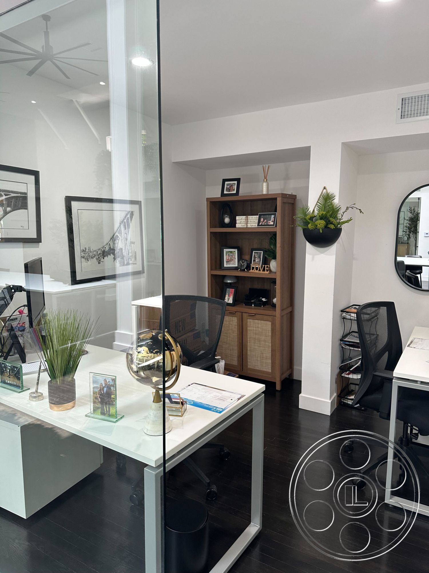 Office 127 - neutral color scheme, glass partition walls, modern accessories, indoor plants for decor, clean lines architecture, modern office design, contemporary office furniture, open plan workspace, hardwood office flooring, functional workspace environment, framed wall art decor, minimalist desk setup, light fixture on ceiling, stylish bookshelf unit, compact desk with storage, black ergonomic office chair, decorative globe display, round mirror accent, cozy office nook, bright natural light ambiance