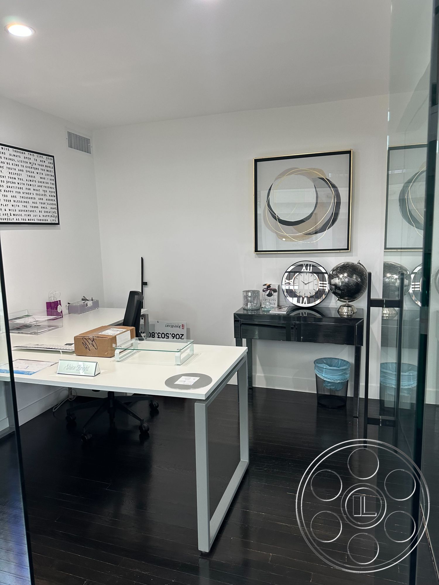 Office 127 - dark hardwood flooring, framed wall art, contemporary aesthetic, black office chair, decorative globe, white painted walls, interior office space, contemporary office furniture, glass partition wall, modern office decor, minimalist desk design, metal clock accents, transparent desk accessories, stylish wastebasket, organized workspace layout