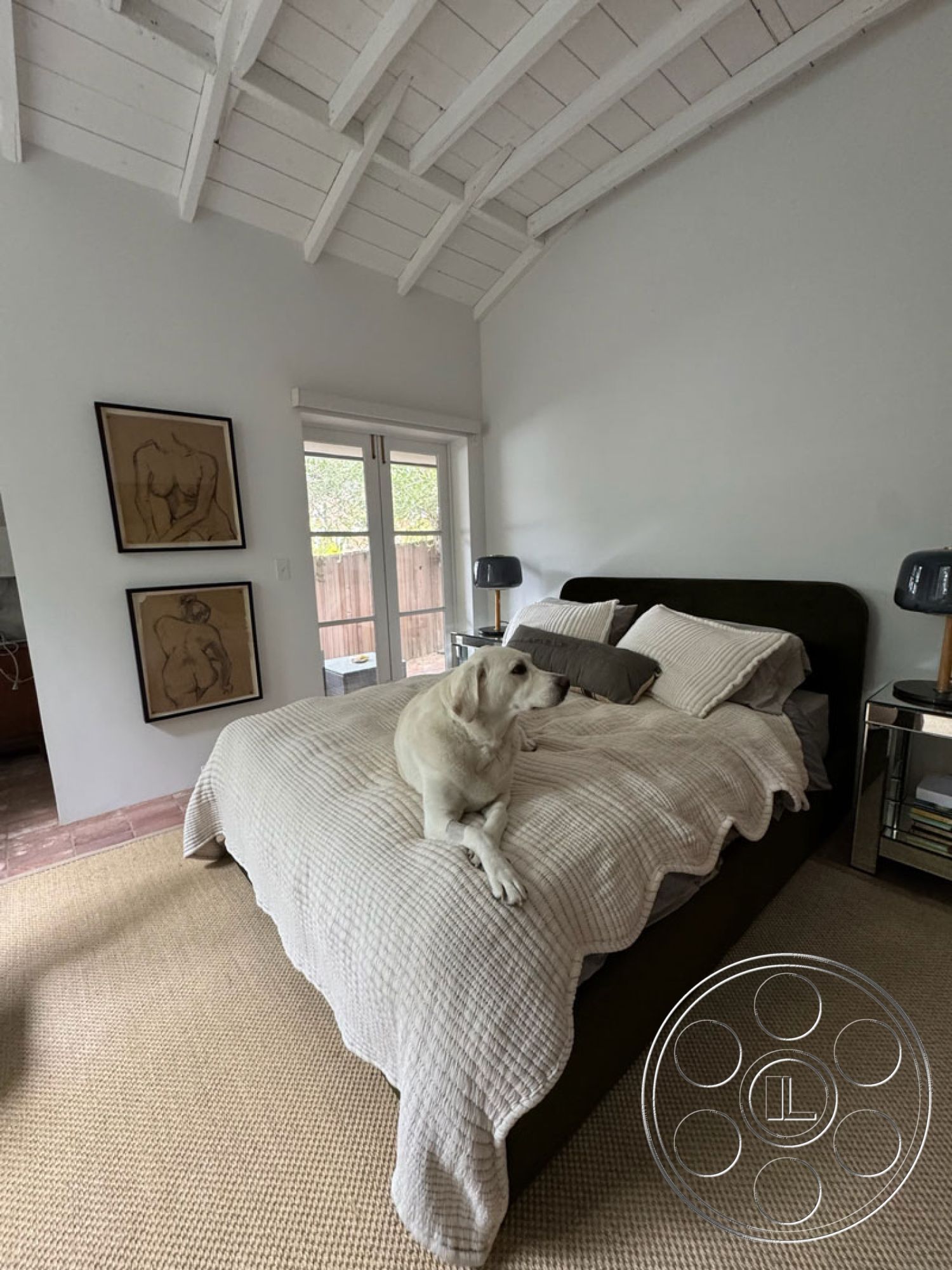 Spanish 165 - minimalist decor, natural light, spacious layout, earthy color palette, framed wall art, plush throw pillows, textured beige area rug, interior bedroom, hardwood bedroom floors, white painted walls, floor-to-ceiling glass doors, vaulted white wood ceiling, queen-sized upholstered bed, neutral-colored bed linens, chrome bedside table, simple window treatments, relaxed coastal design