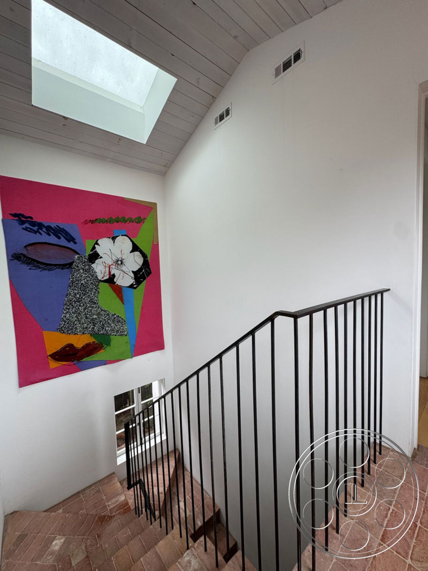 Spanish 165 - interior textured plaster wall, interior white painted walls, interior minimalist design, interior brick staircase flooring, interior straight staircase with metal railings, interior wooden ceiling with skylight, interior vibrant contemporary art wall, interior natural light from skylight, interior geometric artwork, interior open space