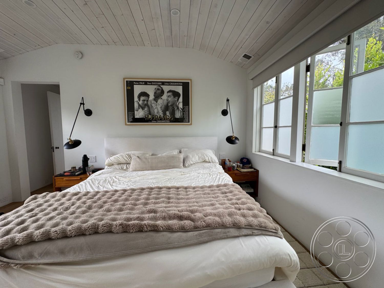 Spanish 165 - hardwood bedroom floors interior, wooden bed frame interior, neutral color palette interior, white painted walls interior, wood beam ceiling interior, natural light from windows interior, modern minimalist design interior, shiplap ceiling interior, plush throw blanket interior, wall-mounted reading lamps interior, textured bedding interior, built-in nightstand interior, framed wall art interior, frosted glass window treatment interior, angled roofline ceiling interior