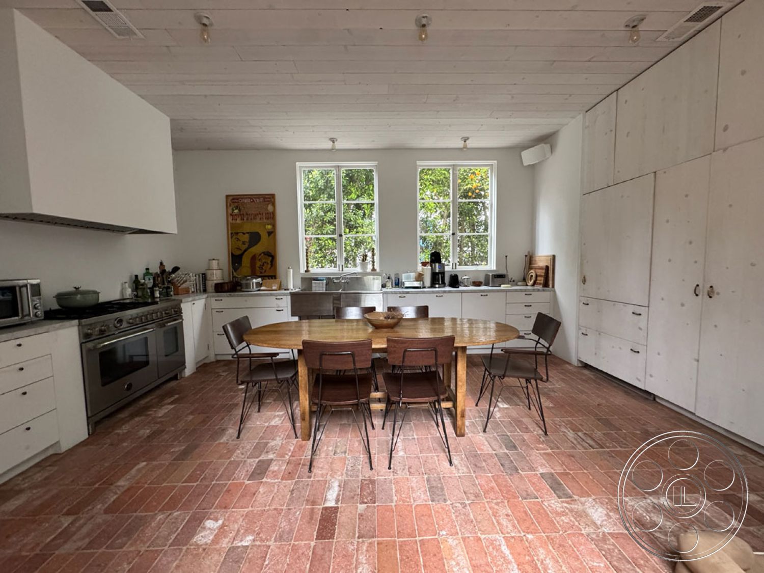 Spanish 165 - neutral color palette, contemporary design, light wood dining table, modern dining chairs, exposed wood ceiling beams, stainless steel kitchen appliances, interior kitchen space, open kitchen layout, functional storage solutions, large windows with garden view, urban kitchen setting, natural light ambiance, brick floor tiles, white shiplap ceiling, white cabinetry with minimalist handles