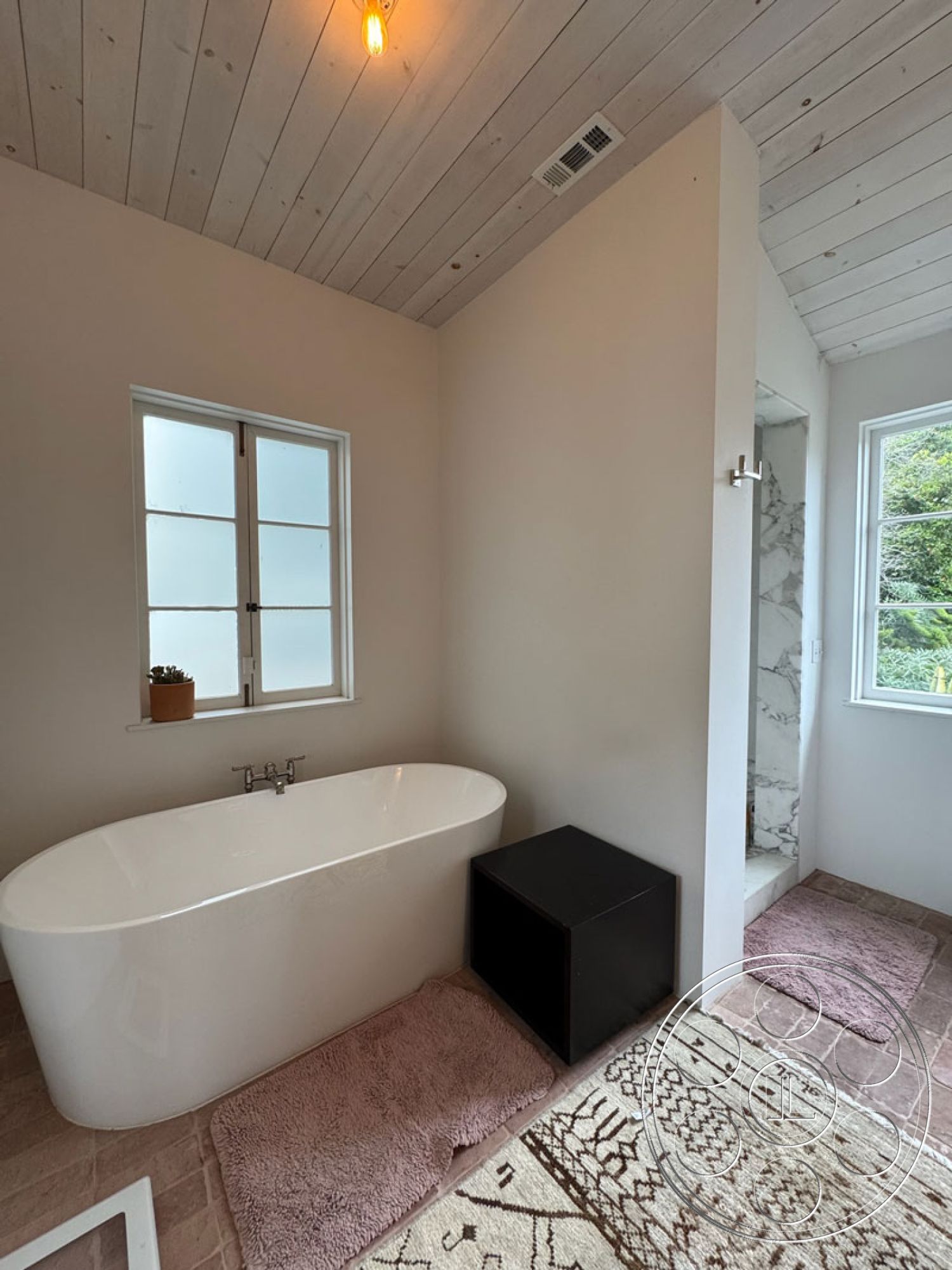 Spanish 165 - neutral color palette, minimalist design, modern bathroom, shiplap ceiling, white painted walls, freestanding soaking tub, marble shower walls, natural light windows, black matte storage cube, luxury bathroom rugs, wooden floor tiles, plant accent decor, bright pendant lighting