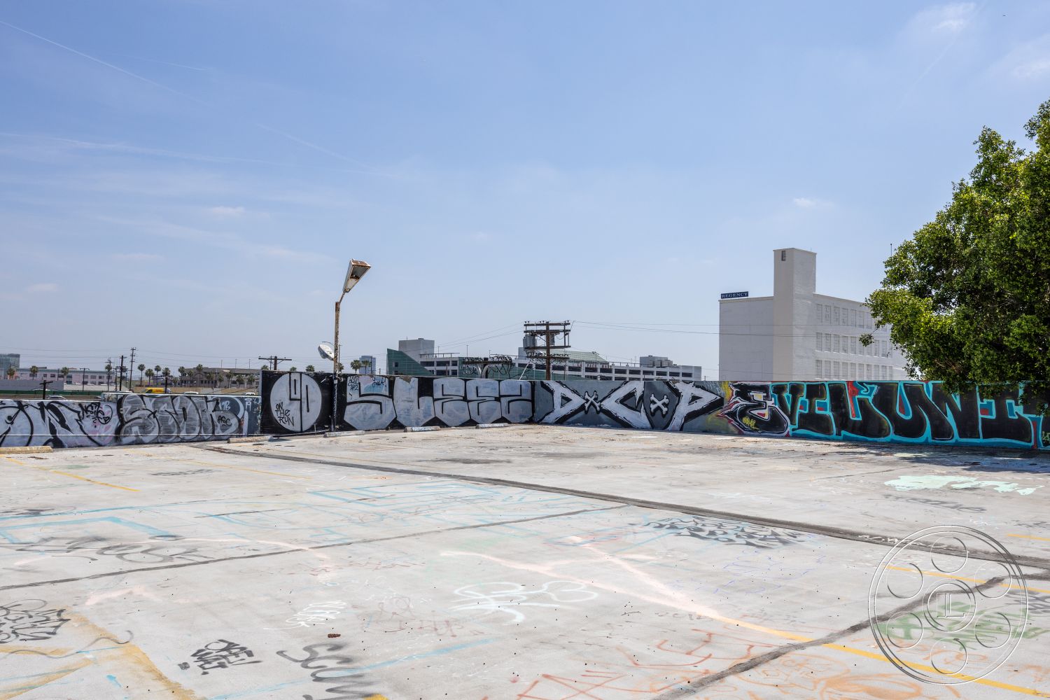 Rooftop 51 - minimalist design elements, metal accents, urban landscape, concrete surface, open-air environment, city skyline view, sunlight exposure, urban outdoor space, graffiti wall art, industrial setting, exposed concrete rooftop, light pole fixture, plastered walls with art, commercial building backdrop, contemporary urban architecture, asphalt surroundings, high-rise buildings in distance, pavement texture, interior urban canvas