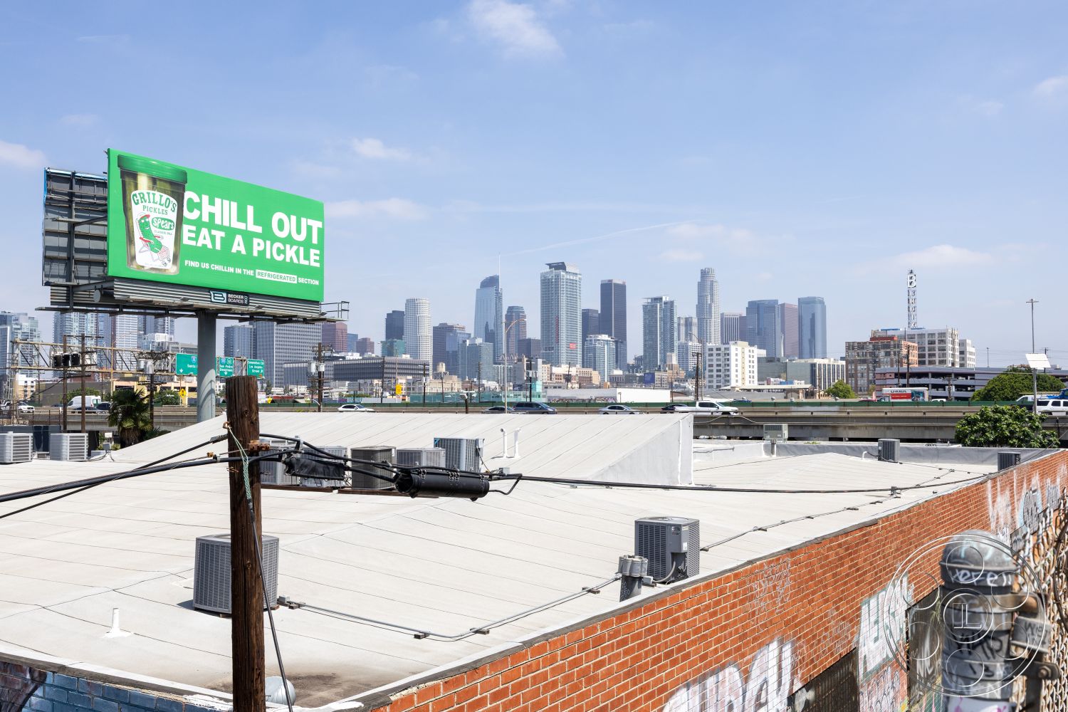 Rooftop 51 - urban landscape, contemporary architecture, commercial building, urban rooftop, urban skyline view, mixed-use development, high-rise buildings, asphalt parking lot, industrial setting, flat rooftop, exterior brick wall, city environment, surrounding cityscape, billboard signage, concrete skyline, metal electrical poles, glass facade buildings, graffiti on exterior wall, street-level view, environmentally integrated structures