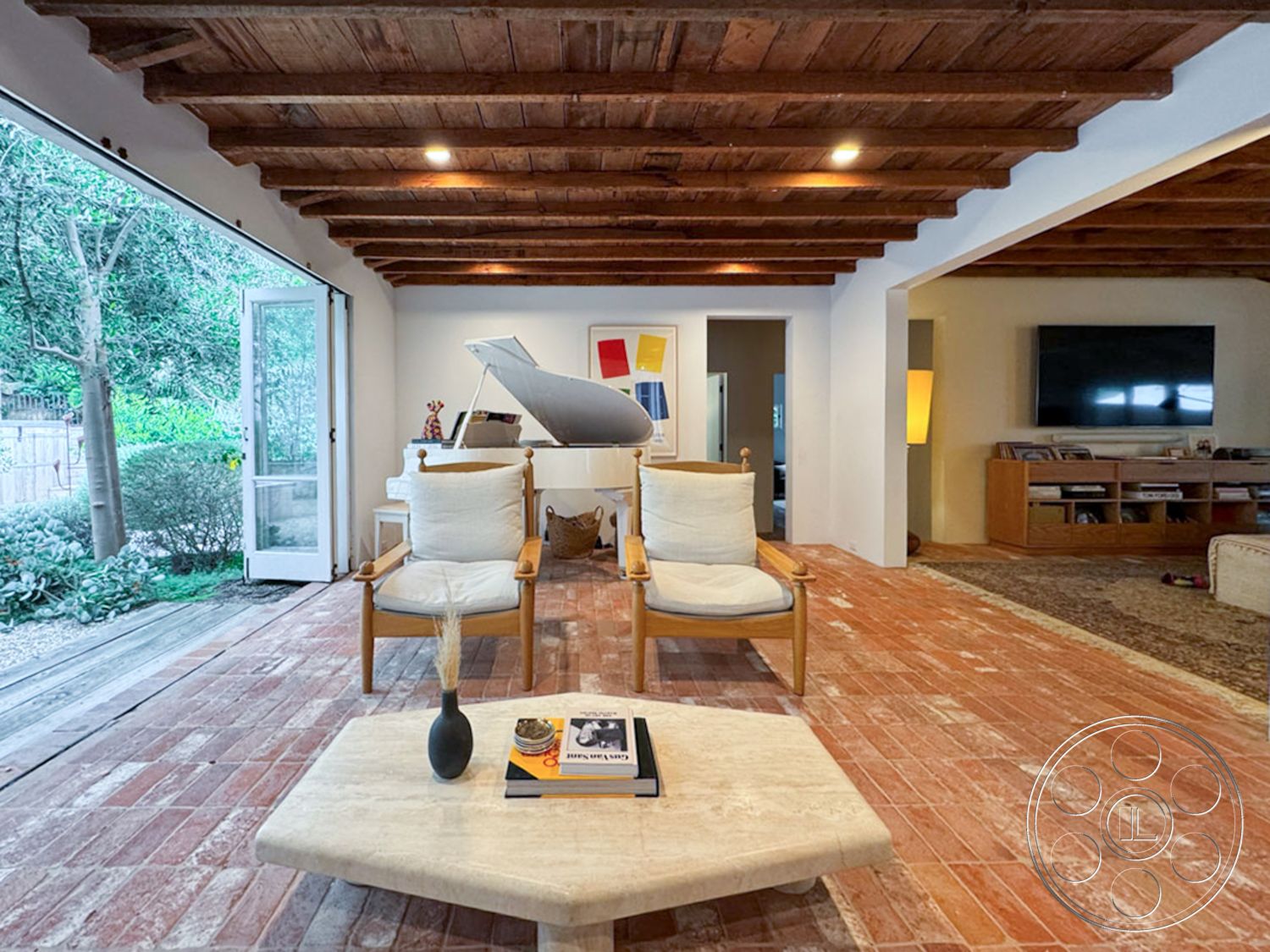 Spanish 165 - natural light interior, wooden accent chair interior, exposed wood ceiling beams interior, white painted walls interior, contemporary design interior, brick flooring interior, modern furniture interior, glass patio doors interior, open living space interior, geometric coffee table interior, greenery view exterior, minimalist decor interior, piano in living room interior, gathering space interior, textured wall treatment interior