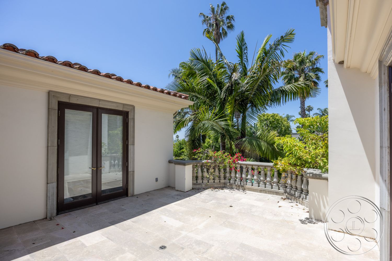 Medit 165 - stone details, natural stone flooring, Mediterranean architecture, lush tropical landscaping, outdoor relaxation area, open air setting, sunlit outdoor space, palm tree views, double glass doors, exterior terrace, smooth stone tile patio, ornamental stone railing, white stucco wall finish, clay tile roof accents, surrounding garden terrace
