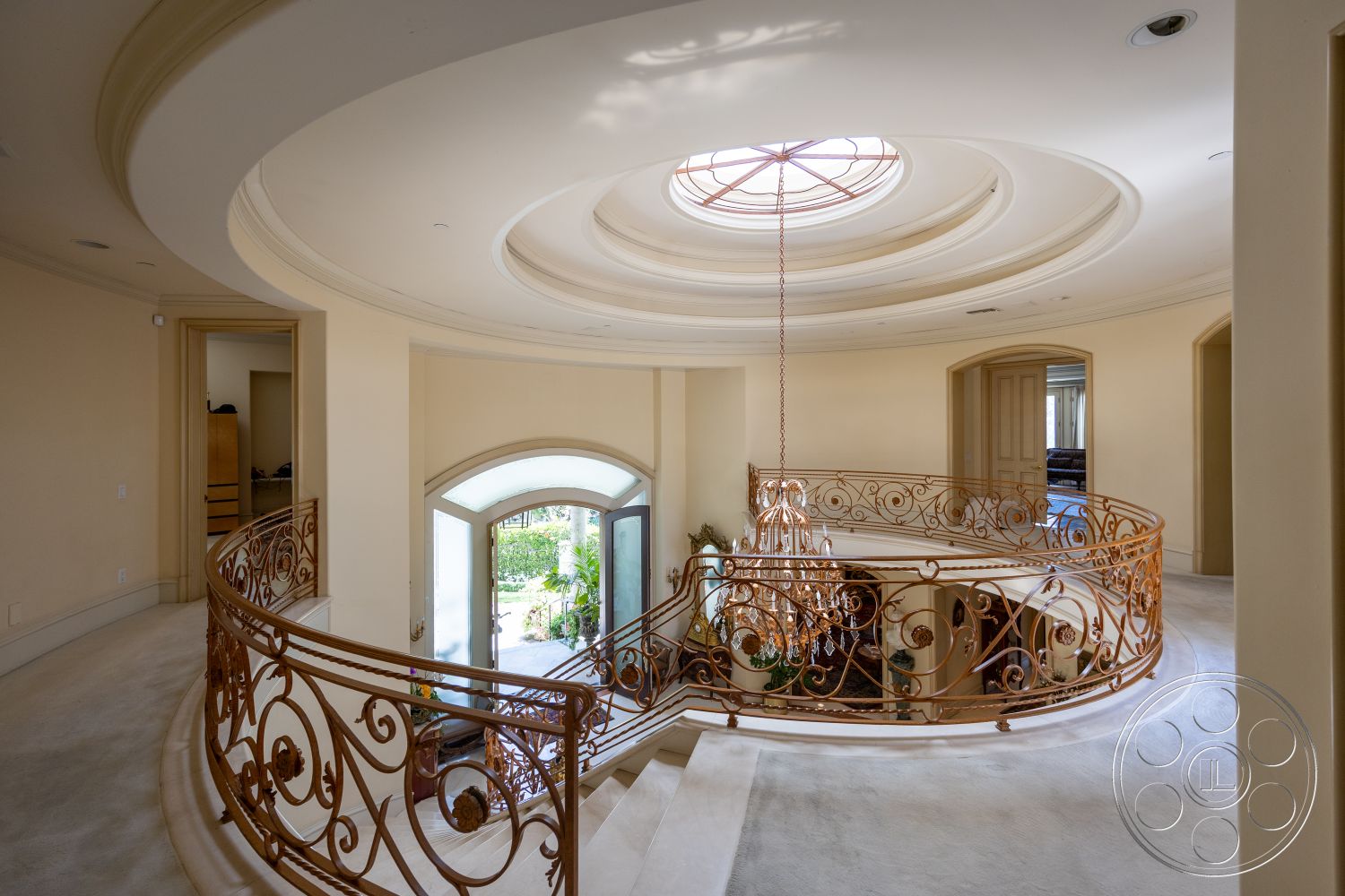 Medit 165 - interior plush carpet flooring, exterior arched doorways, interior circular staircase, exterior double doors with glass insert, interior coffered ceiling with circular design, exterior decorative wrought iron railing, interior expansive entryway with natural light, interior chandelier with crystals, interior detailed crown molding, interior wall treatments with neutral paint, interior large skylight for natural illumination, interior elegant railing design with scroll patterns, exterior garden view through entryway, interior modern luxury finishes, interior open floor plan concept