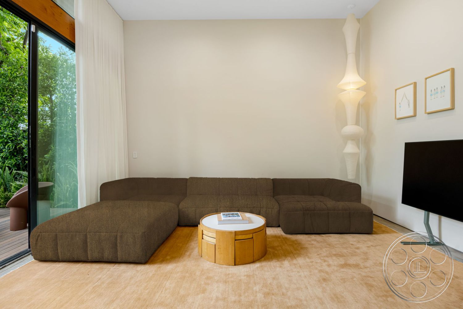 Modern 508 - minimalist decor, natural light, glass sliding doors, open concept design, brown sectional sofa, light beige area rug, modern floor lamp, interior living room, textured beige wall treatment, wood coffee table with circular design, framed minimalist wall art, indoor greenery view, contemporary design details
