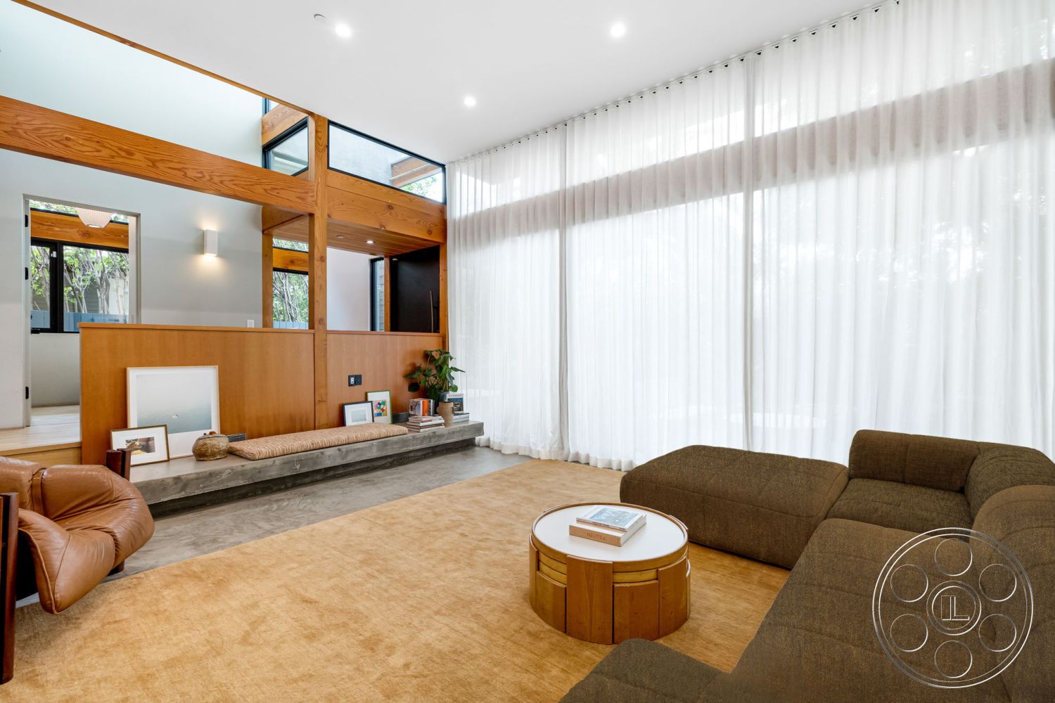Modern 508 - neutral color palette, natural light, open floor plan, sliding glass doors, wood accent wall, geometric coffee table, indoor plant decor, tan area rug, bright and airy space, low-profile furniture, textured fabric upholstery, contemporary architectural style, exposed wood ceiling beams, modern sectional sofa, interior minimalist design, concrete living room floor, full-height glass windows, sheer white drapery, built-in bench seating, rustic-chic decor elements