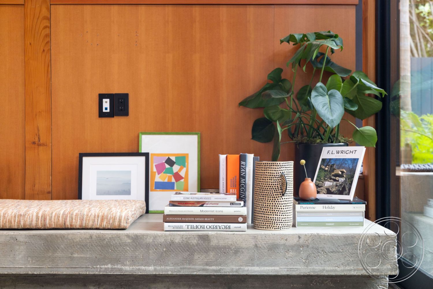 Modern 508 - neutral color palette, decorative ceramic vase, minimalist interior design, decorative accent wall, green indoor plant accent, interior wooden wall paneling, exposed concrete countertop, textured fabric cushion, framed abstract artwork, framed landscape photography, contemporary book collection, smooth concrete shelf surface, modern lighting switch, artistic coffee table display, industrial style home decor