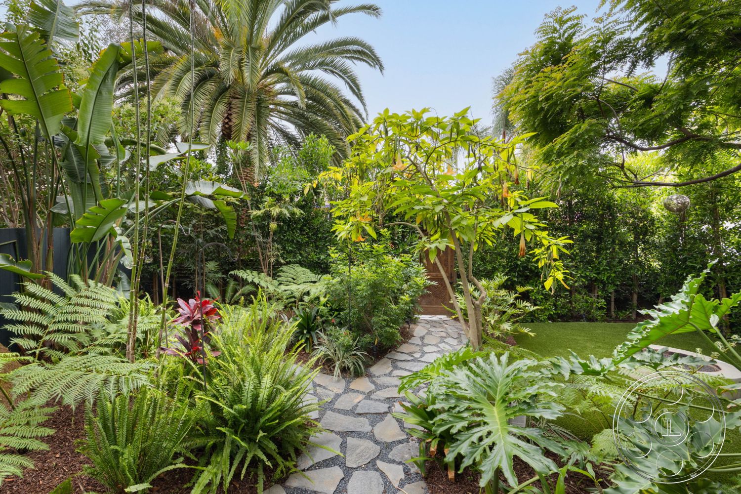 Modern 508 - scenic garden view, lush tropical landscaping, outdoor relaxation area, exterior stone pathway, native plant garden, irregular flagstone walkway, palms and ferns garden setting, wooden garden gate, interior/outdoor greenery, soft grass lawn, garden path with natural stone, dense foliage surrounding pathway, textured gravel accents