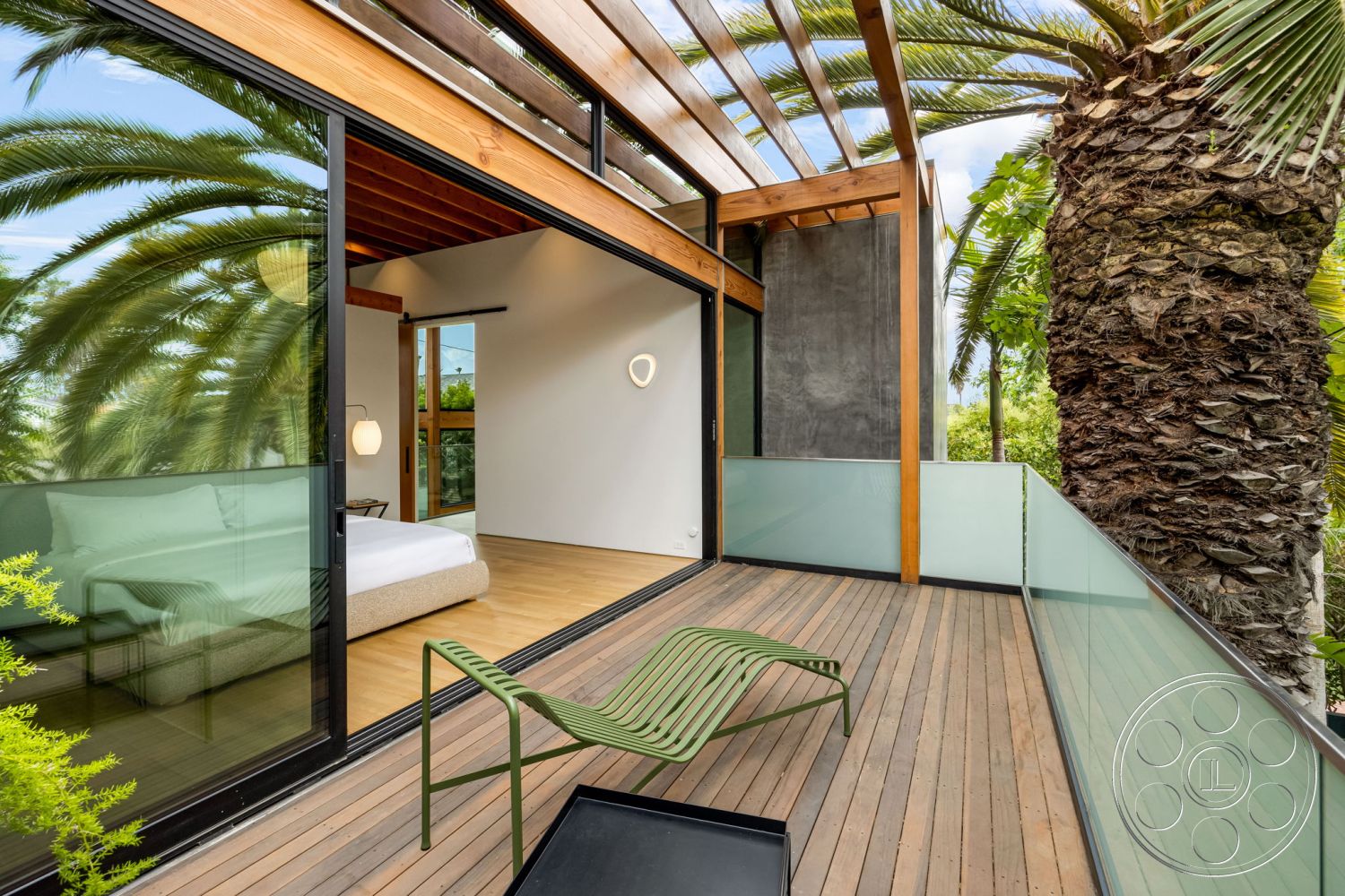 Modern 508 - natural light, exterior, minimalist design, modern design elements, glass railing, floor-to-ceiling windows, concrete wall, outdoor lounge area, city skyline view, contemporary architectural style, wood deck flooring, greenery surrounding, integrated indoor-outdoor living, palm tree landscape, horizontal wood slat roof, open-air balcony