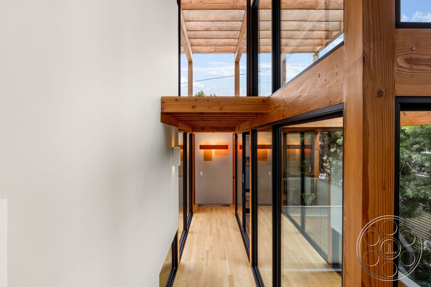 Modern 508 - natural light, open concept design, floor-to-ceiling windows, outdoor view, textured plaster walls, contemporary interior, exposed wood ceiling beams, glass partition walls, modern minimalist aesthetic, wood beam ceiling, sleek architectural lines, hardwood corridor flooring, modern corridor