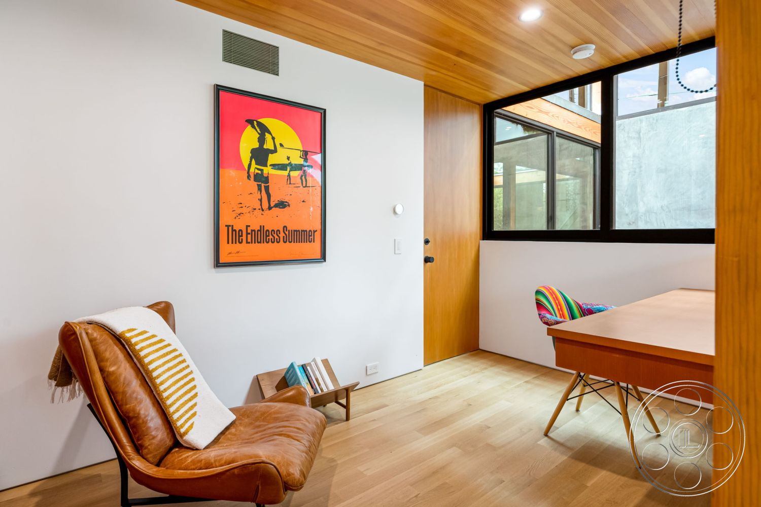Modern 508 - interior natural light, interior minimalist decor, interior hardwood flooring, interior white painted walls, interior wood beam ceiling, interior open layout, interior framed artwork, interior warm color palette, interior colorful patterned chair, interior glass window wall, interior modern desk, interior leather armchair, interior sliding wood door, interior accent rug
