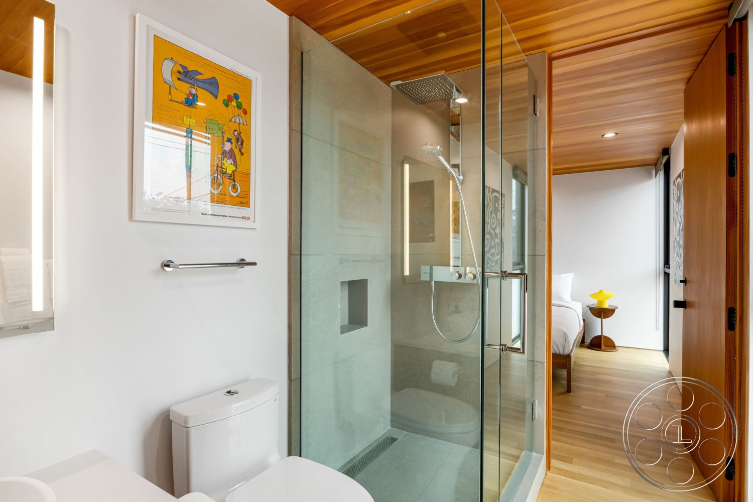 Modern 508 - open concept living space, white painted walls interior, modern toilet fixture, floating wood vanity, marble bathroom flooring, contemporary wall art, wood door with black handle, glass shower enclosure interior, pine wood ceiling panels, polished concrete shower wall, single yellow accent table, minimalistic interior design, LED light fixtures, clear glass partition wall, natural light bathroom, seamless transition to bedroom area, textured bathroom walls, efficient use of space interior