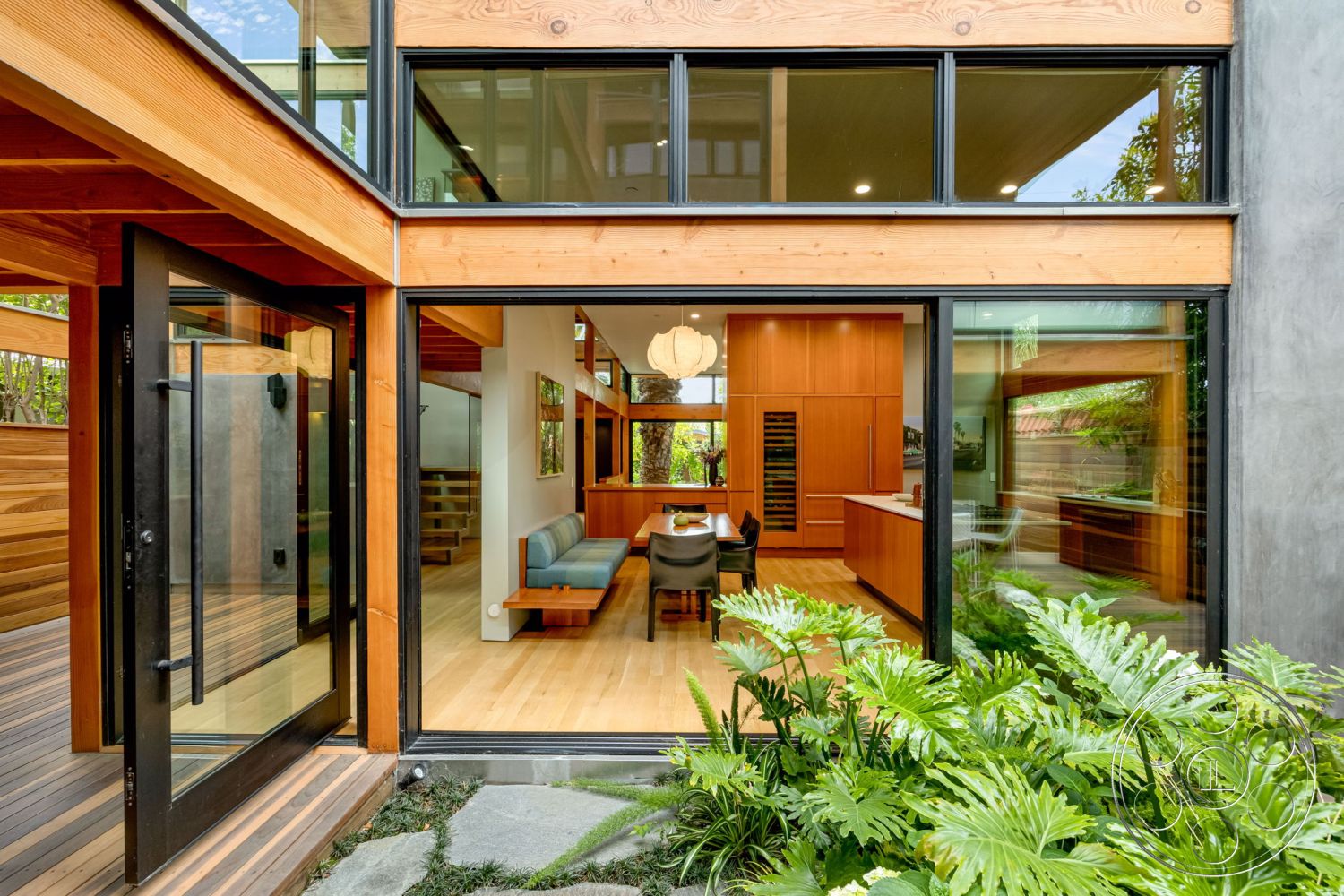 Modern 508 - exposed wooden ceiling, modern architectural style, interior modern pendant lighting, interior open floor plan, exterior stone pathway, interior built-in kitchen cabinets, exterior glass sliding doors, interior stone accent wall, exterior wooden deck flooring, interior natural light through large windows, exterior wood beam construction, interior hardwood floor living room, interior vaulted ceiling with wood beams, interior contemporary dining area, exterior landscaped garden with ferns, exterior concrete wall panels, interior tile backsplash kitchen, exterior steel frame windows, exterior courtyard view, interior dining space with seating, interior utility pantry with shelving