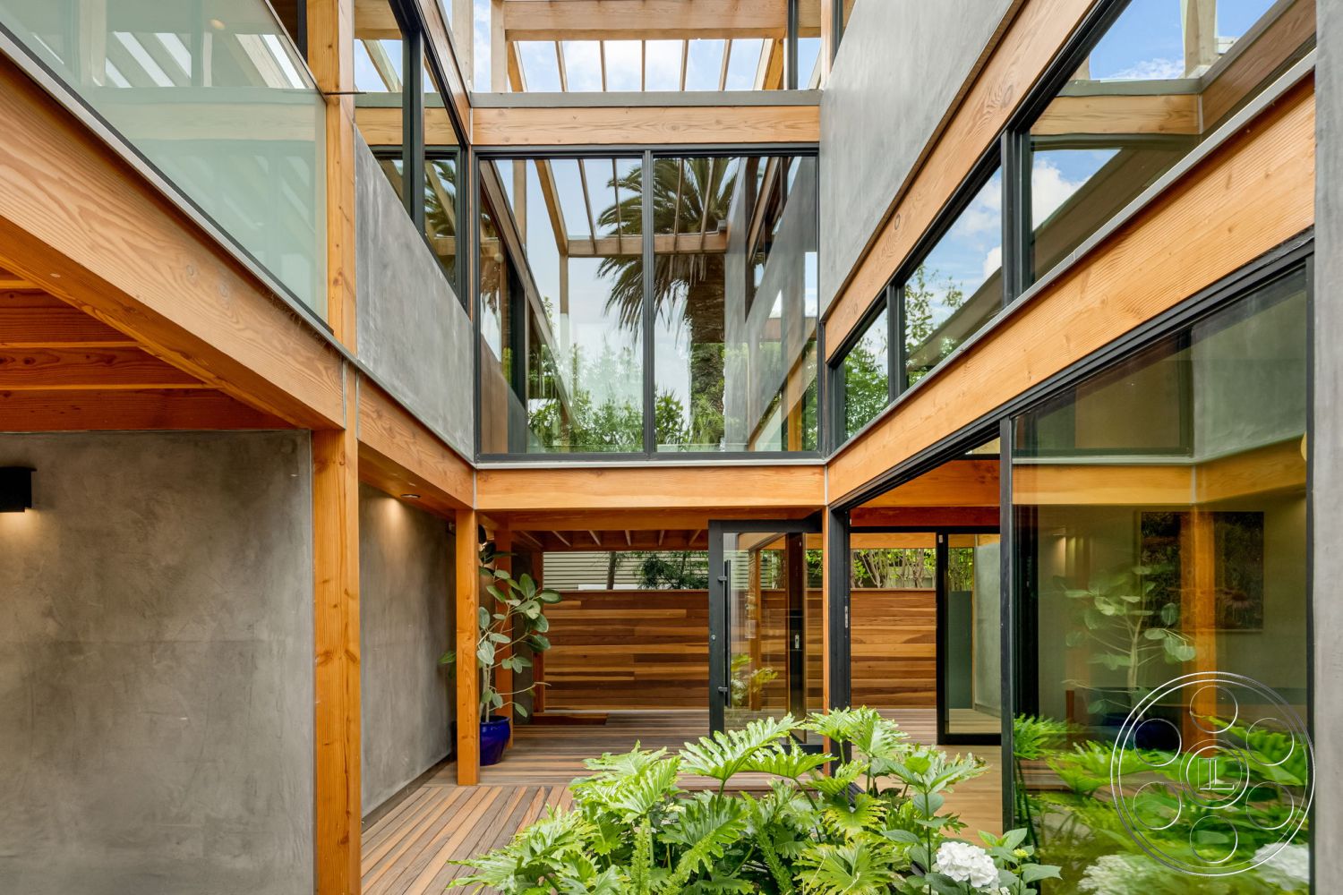 Modern 508 - modern architectural style, open-air design, textured plaster walls, exposed wood structural elements, lush garden setting, hardwood deck flooring, wood beam ceiling, concrete wall finish, floor-to-ceiling glass windows, natural light emphasis, exterior courtyard, greenery accent features, vertical wood slat privacy screens