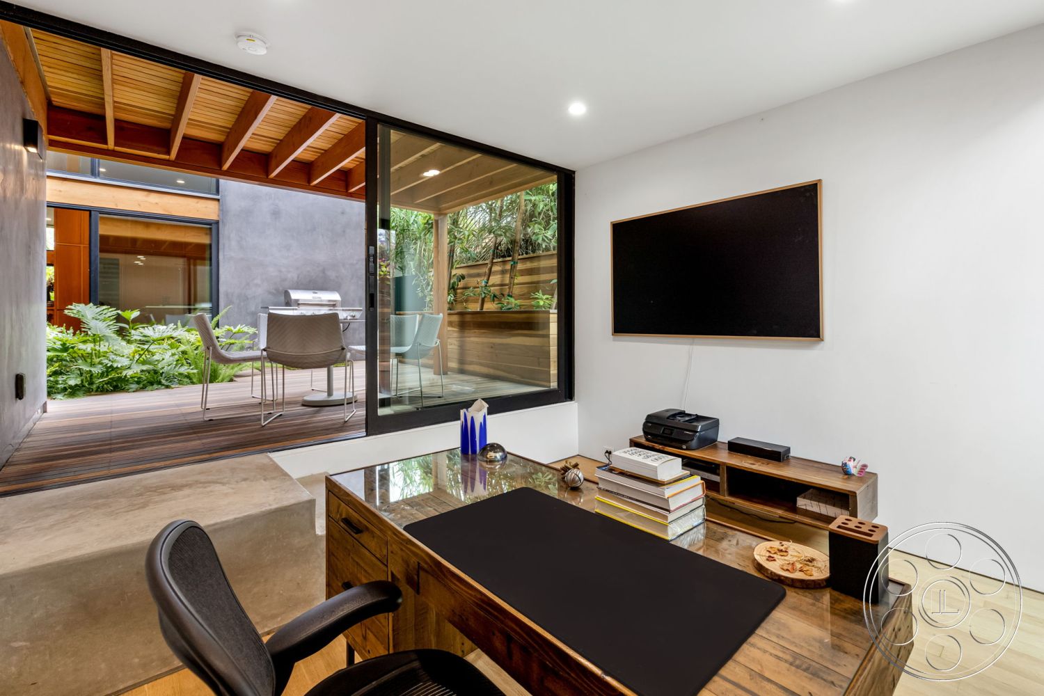 Modern 508 - minimalist decor, hardwood flooring, contemporary design, indoor plants, glass sliding doors, wooden deck, sitting area, urban environment, outdoor view, media console, modern desk, blackboard wall, open-plan layout, wood beam ceiling, white painted walls, natural light exposure, interior office space, concrete desk base, functionally designed workspace, tranquil workspace setting