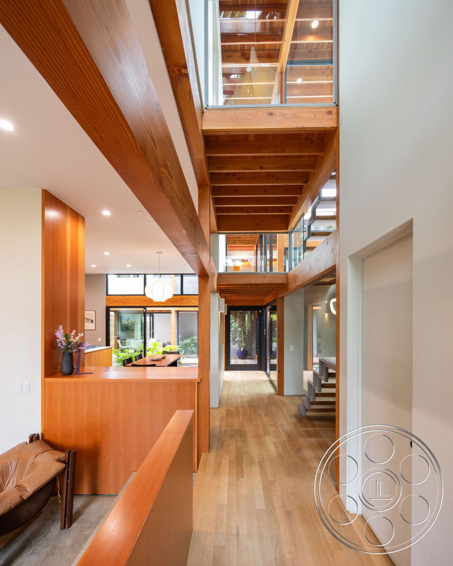 Modern 508 - neutral color palette, hardwood flooring, minimalist design elements, contemporary pendant lighting, floor-to-ceiling windows, spacious living area, textured wall treatments, wood ceiling beams, modern staircase, wood accent walls, glass partition walls, open-concept interior, exposed structural beams, natural light filled spaces, wooden kitchen island, integrated indoor garden, sunlit hallway, elegant home design