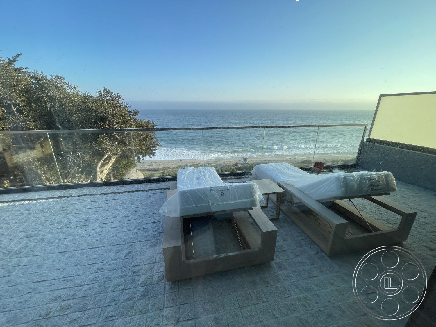Modern 509 - glass railing, textured concrete flooring, coastal setting, open-concept design, large sliding glass doors, modern outdoor lounge area, minimalist furniture design, oceanfront view, exterior deck patio, wood frame structure, breeze block wall detail